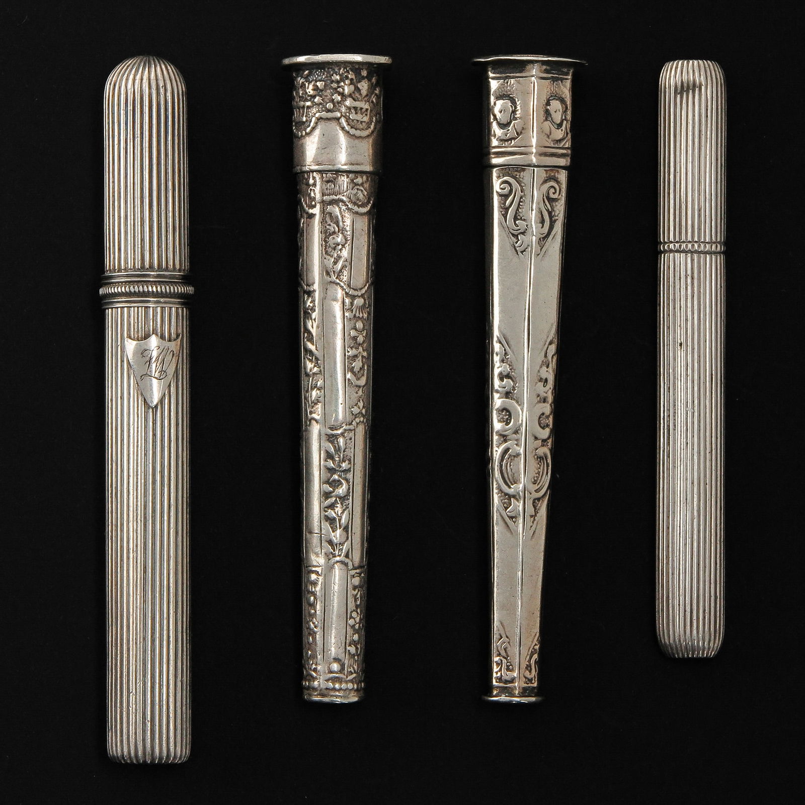 A Collection of Silver Items: consisting of 4 pieces of silver, including 18th century needle cases, longest 92 mm.