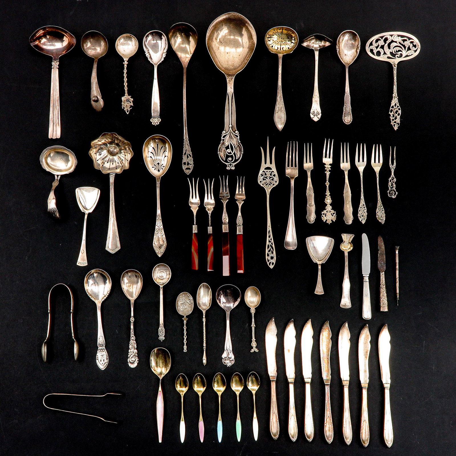 A Collection of Items: Including silver pickle fork, 19th century, with carnelian handle, length 14 cm.
