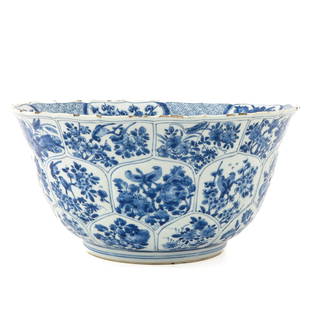 A Large Kangxi Period Serving Bowl: Blue and white floral decor with birds and crickets, Kangxi Mark and Period, 34 cm. in diameter, chips on rim.