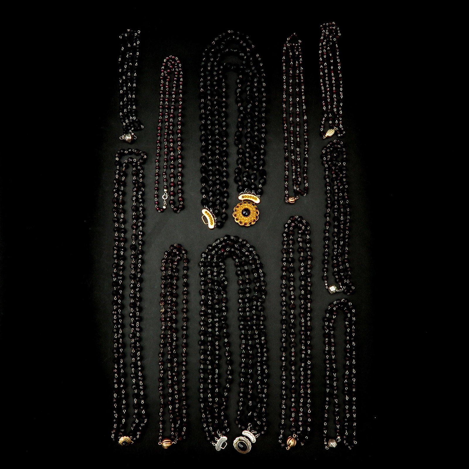 A Collection of 11 Garnet Necklaces: Including gold