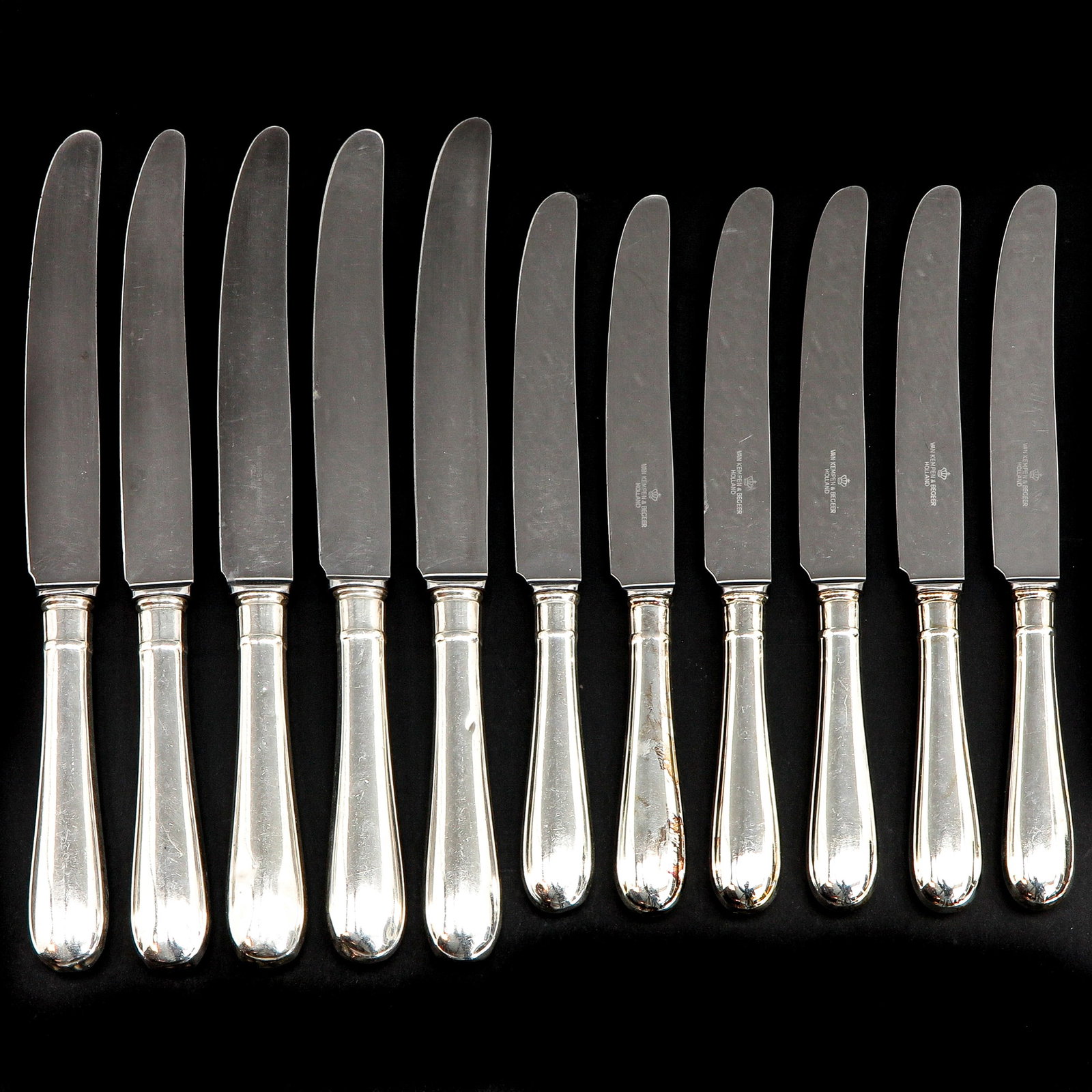 A Collection of 11 Knives: Silver handles, 2nd degree silver, marked Van Kempen, largest length 24 cm.
