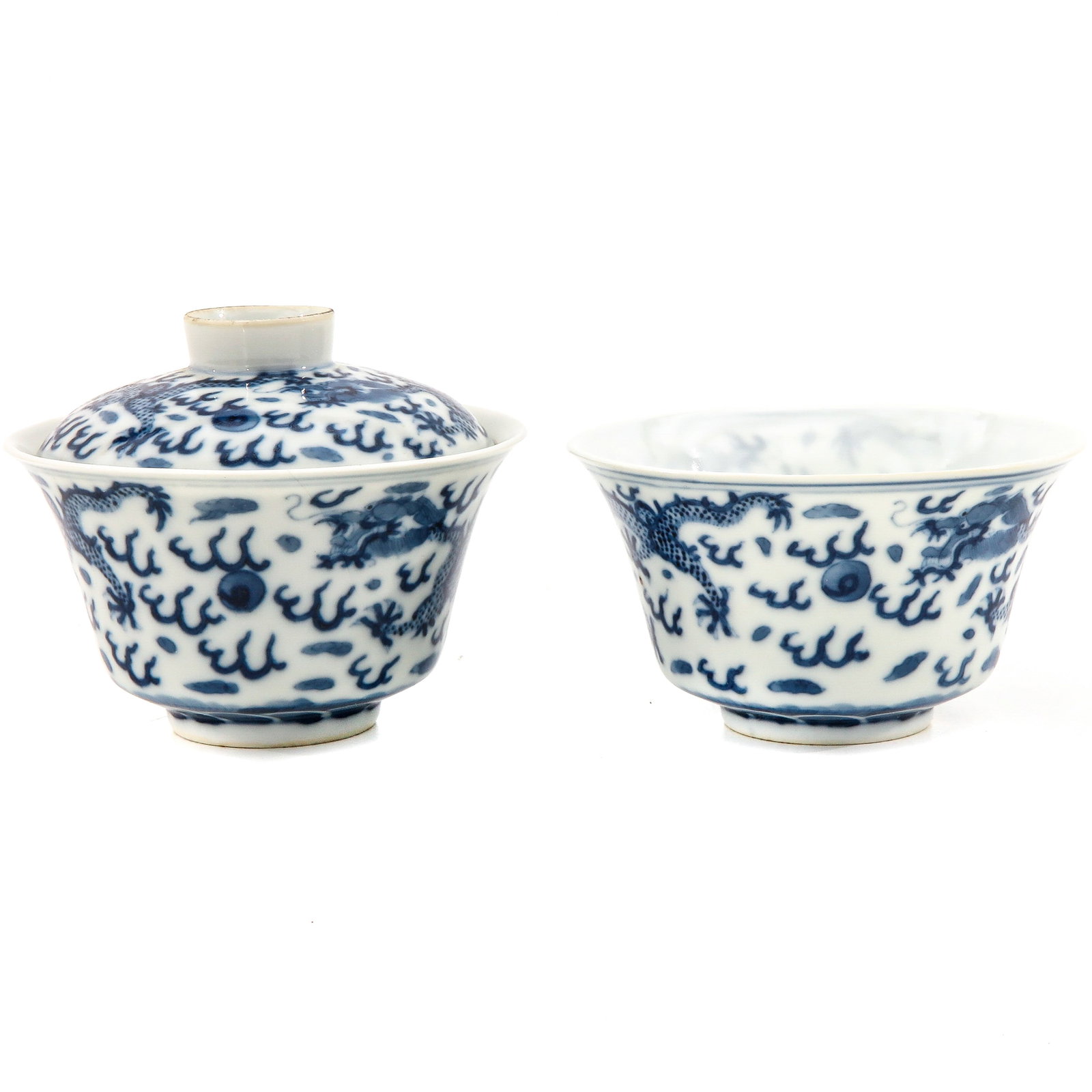 A Pair of Blue and White Cups: 1 cup with cover, decorated with dragons and clouds, Guangxu Mark and Period, cups are 11 cm. in diameter, hairline.