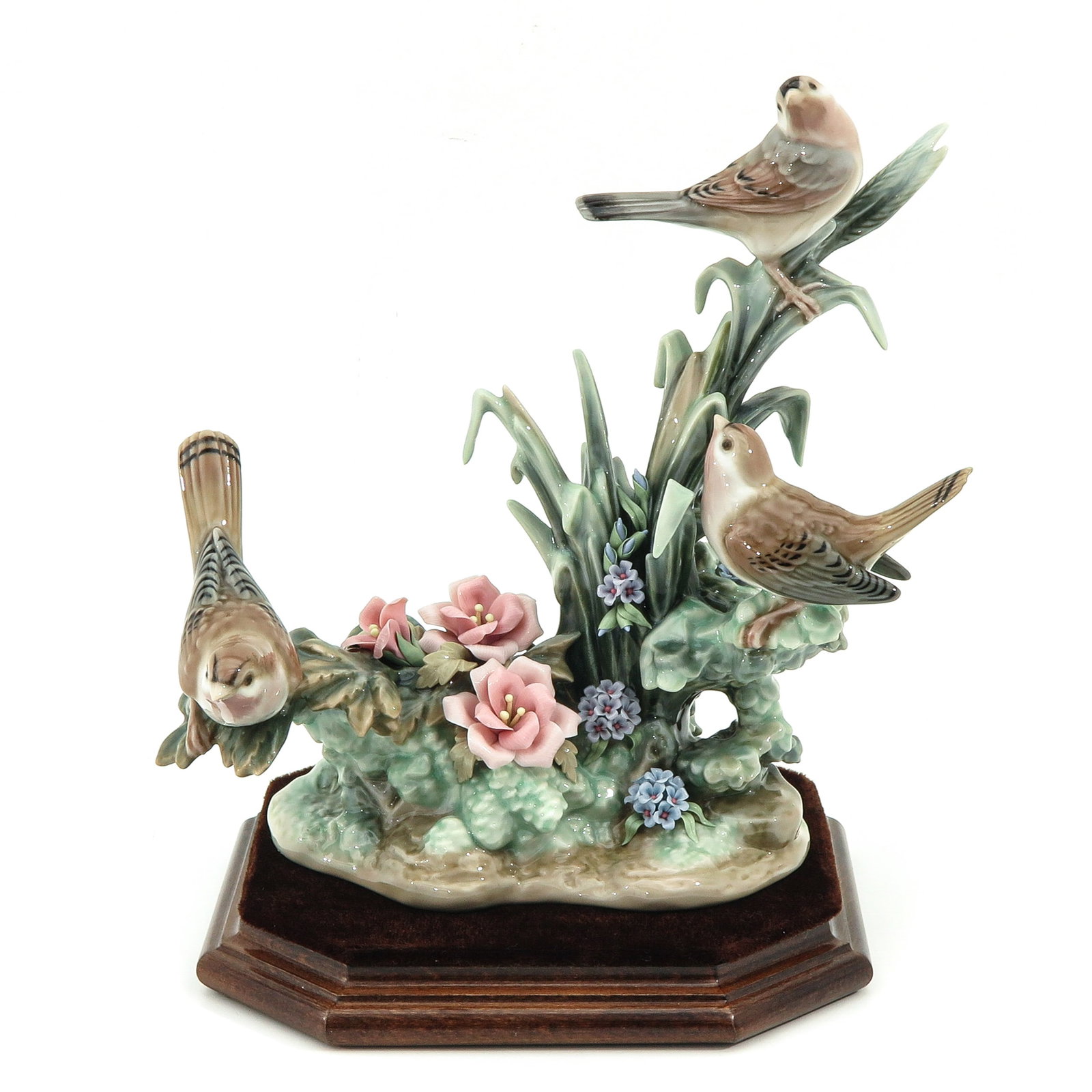 A Lladro Sculpture: Lladro, Losses To Flowers, height 23 cm., on a velvet-covered wooden base, restored.