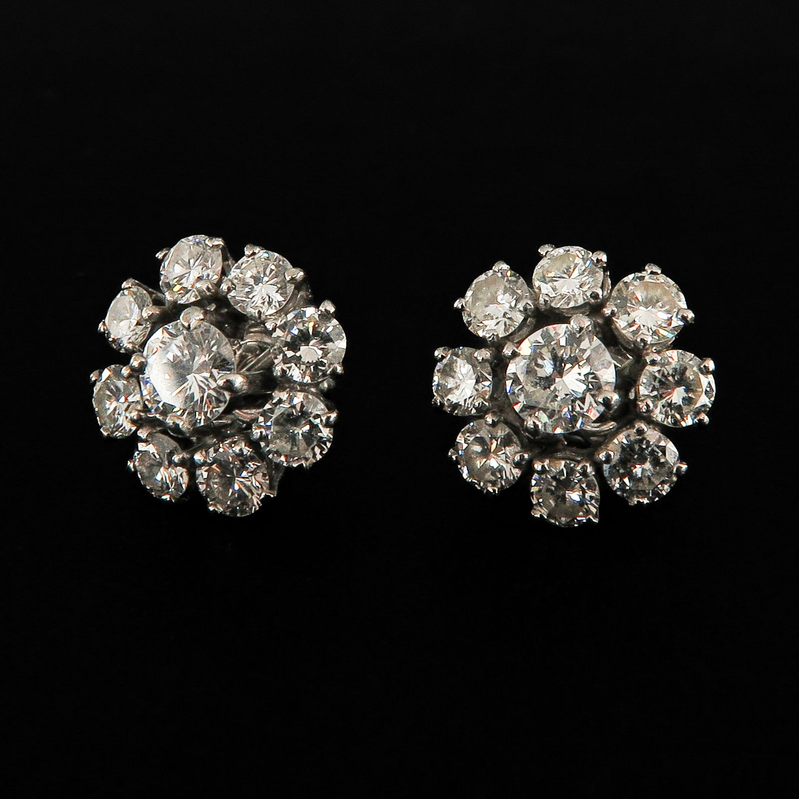 A Pair of Diamond Earrings: Set with 18 brilliant cut diamonds, diameter 10 mm.