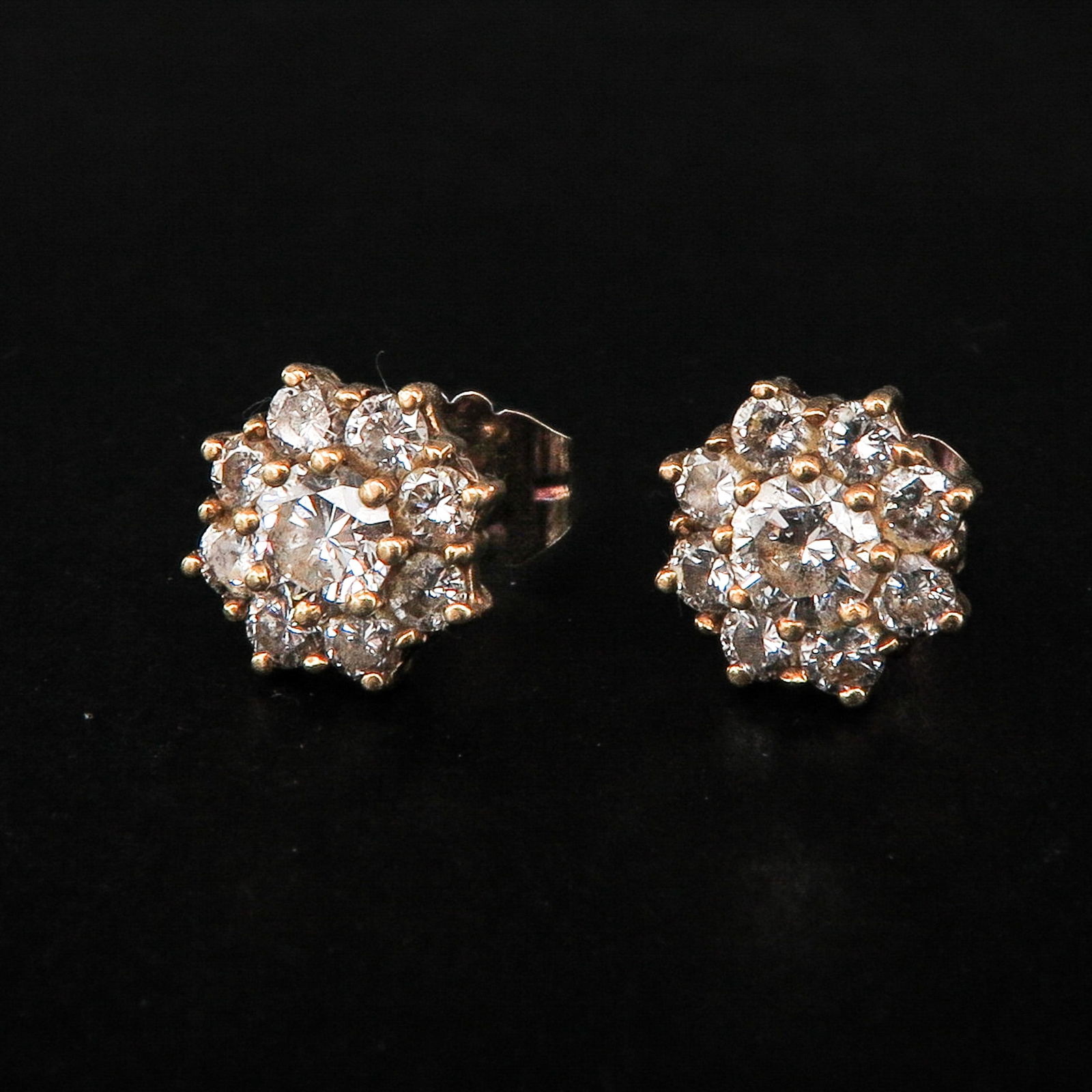 A Pair of Diamond Earrings: 14KG set with 18 brilliant cut diamonds, diameter 10 mm.