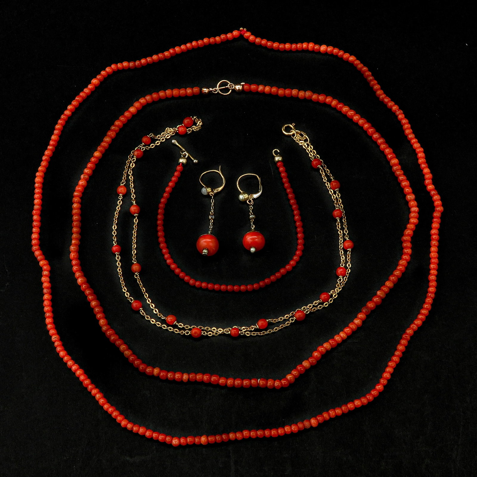 A Collection of Red Coral Jewelry: Consisting of 3 necklaces, a bracelet and a pair of earrings, total weight 28 grams