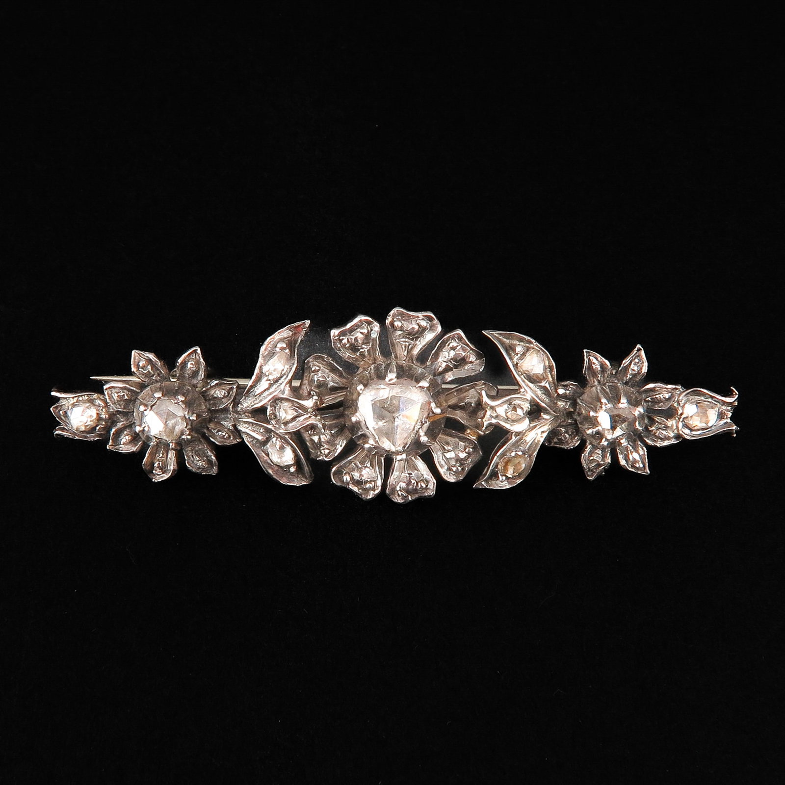 A Diamond Brooch: Set with 11 rose-cut diamonds, length 50 mm.