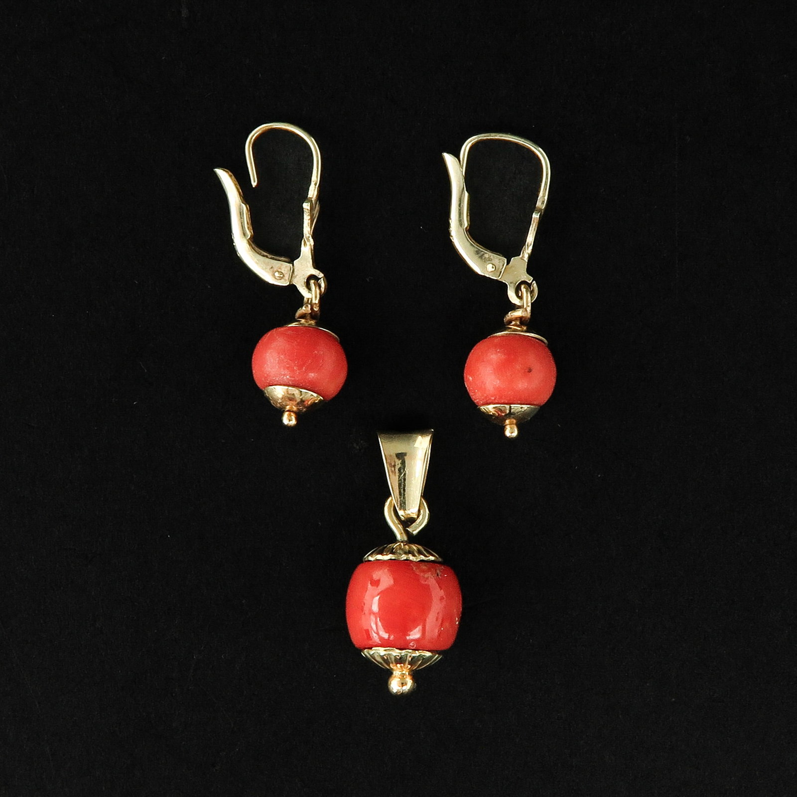 A Collection of Red Coral Jewelry: Consisting of a pair of blood coral earrings and pendant, diameter pendant 10 mm.