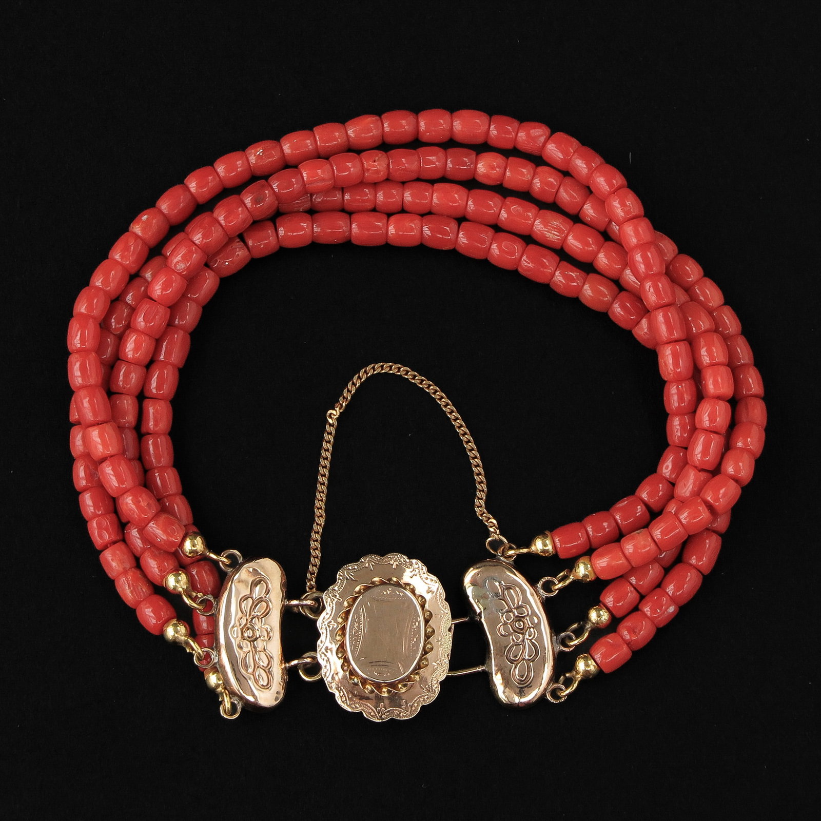 A Red Coral Bracelet: With 4 rows of blood coral, on 14KG clasp, weight 18 grams