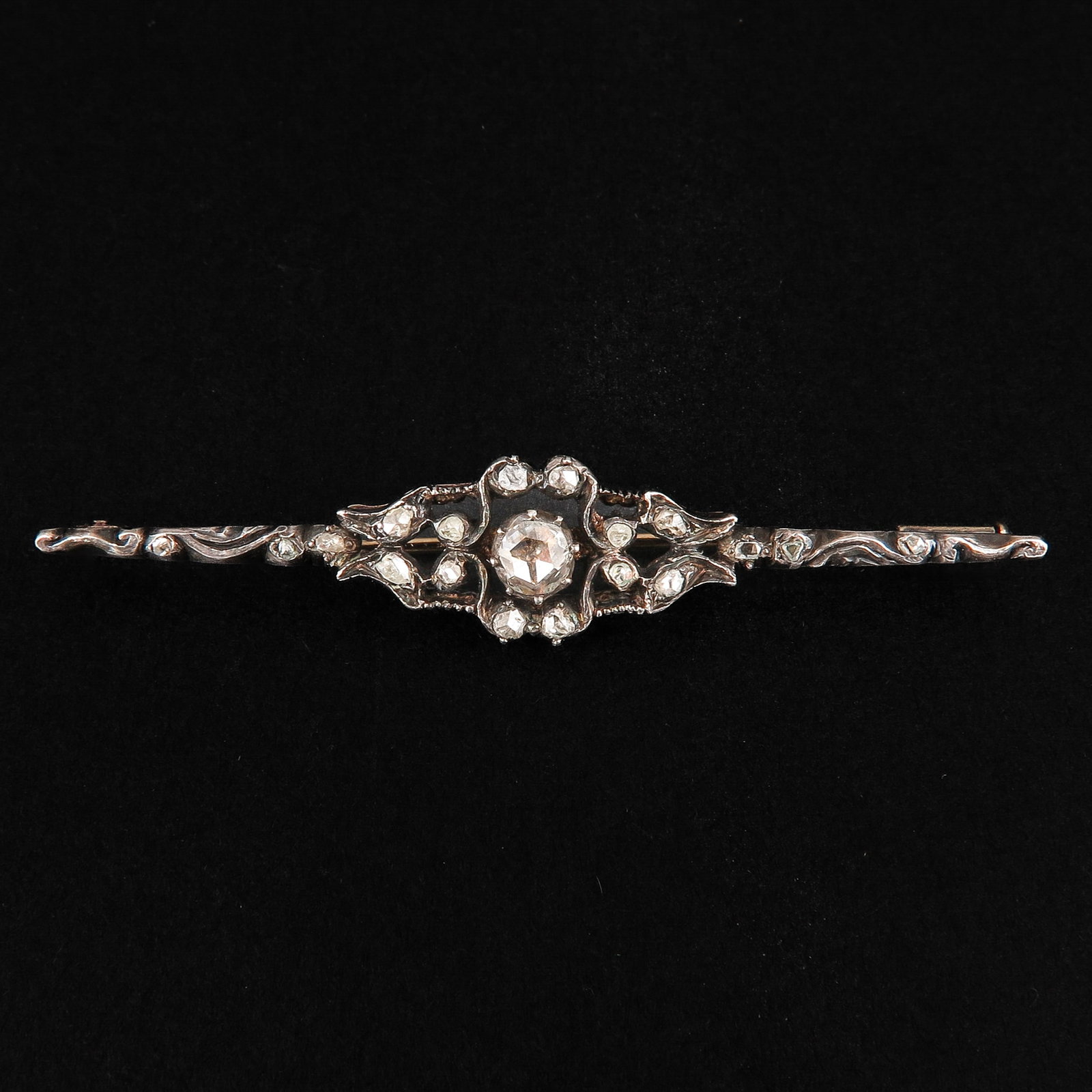 A Diamond Brooch: Silver on gold, set with many rose-cut diamonds, length 54 mm.