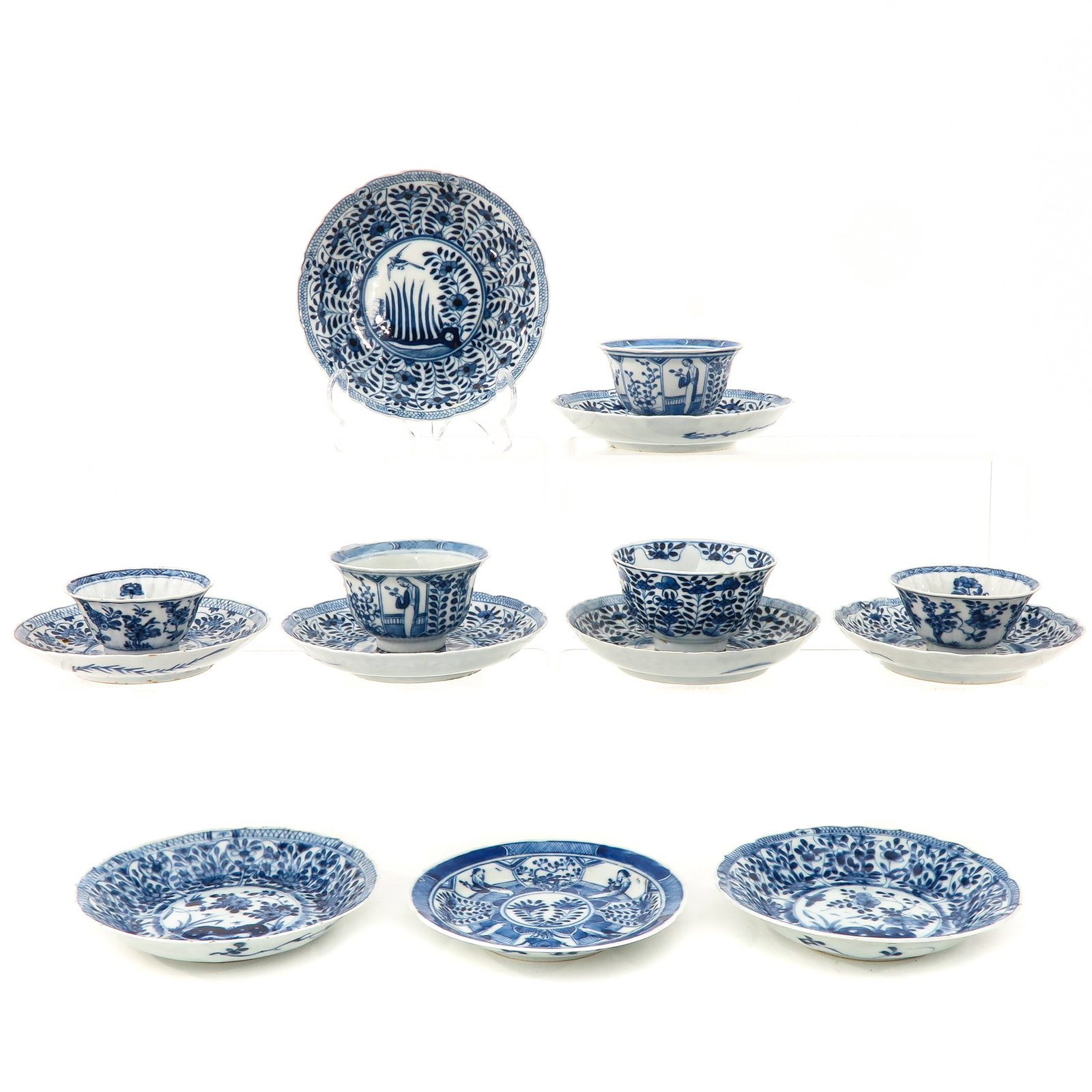 A Collection of Cups and Saucers: Including 5 cups and 9 saucers, in a variety of blue and white decors, largest saucer is 13 cm. in diameter, in diverse conditions.