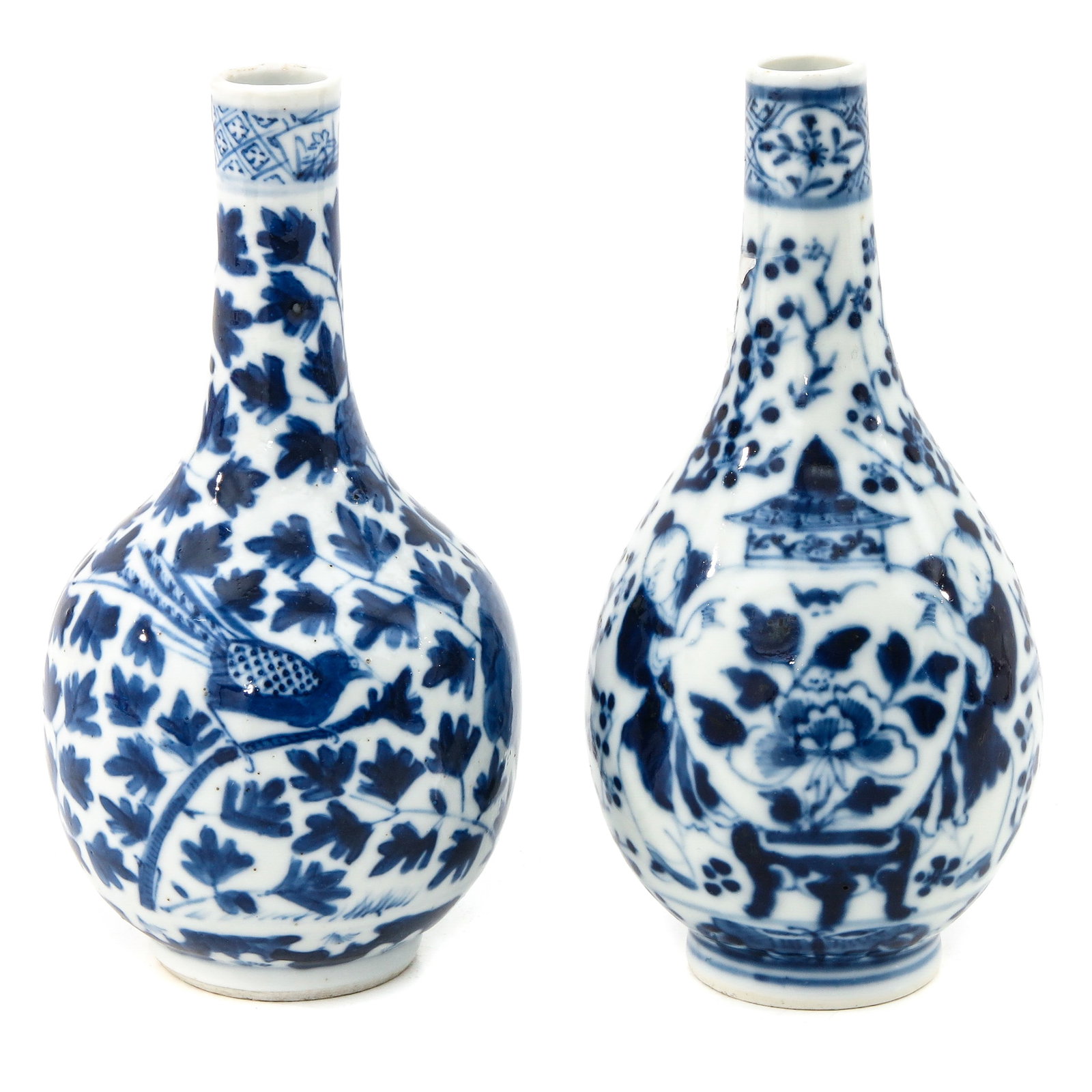 A Pair of Blue and White Vases: Depicting Chinese figures holding a vase, Kangxi, 16 cm. tall, chip.