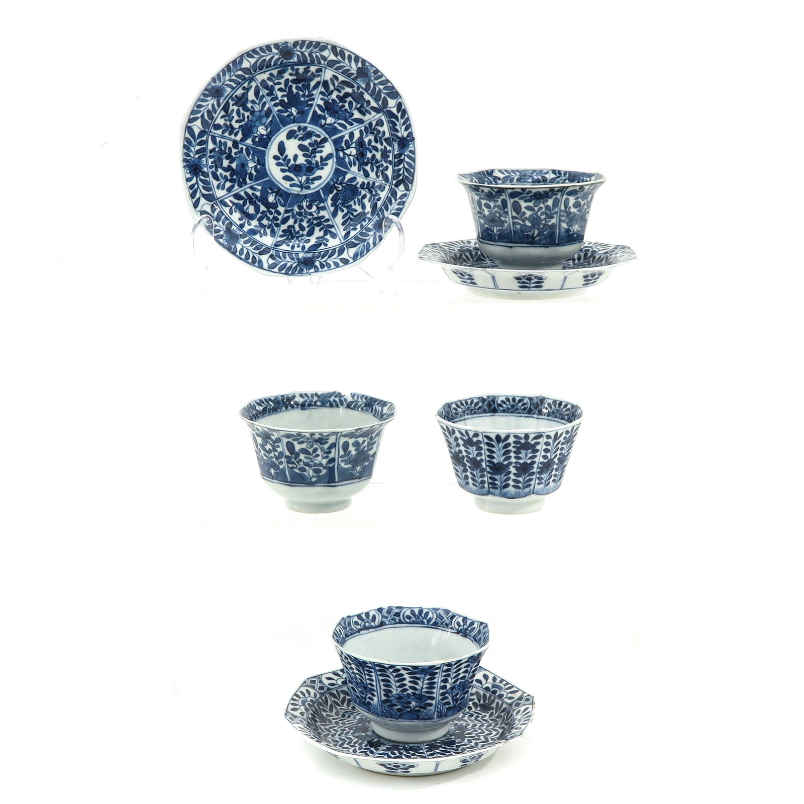 A Collection of Cups and Saucers: 7 pieces, blue and white floral decor, Kangxi mark, saucers are 13 cm. in diameter, chip and hairline.