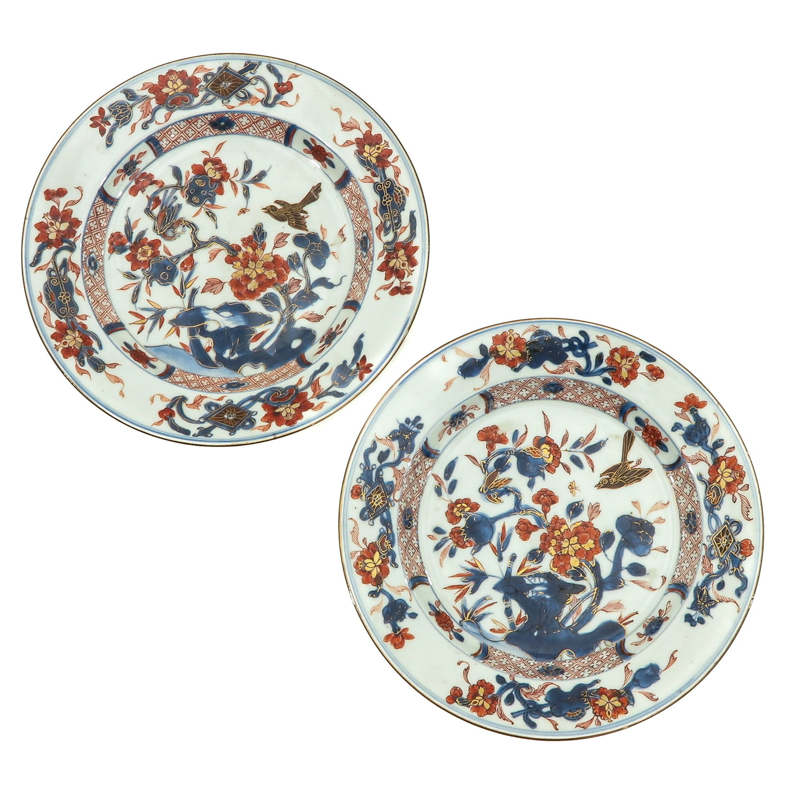 A Pair of Imari Plates: Iron red, blue and gilt floral decor, 18th Century, 23 cm. in diameter.