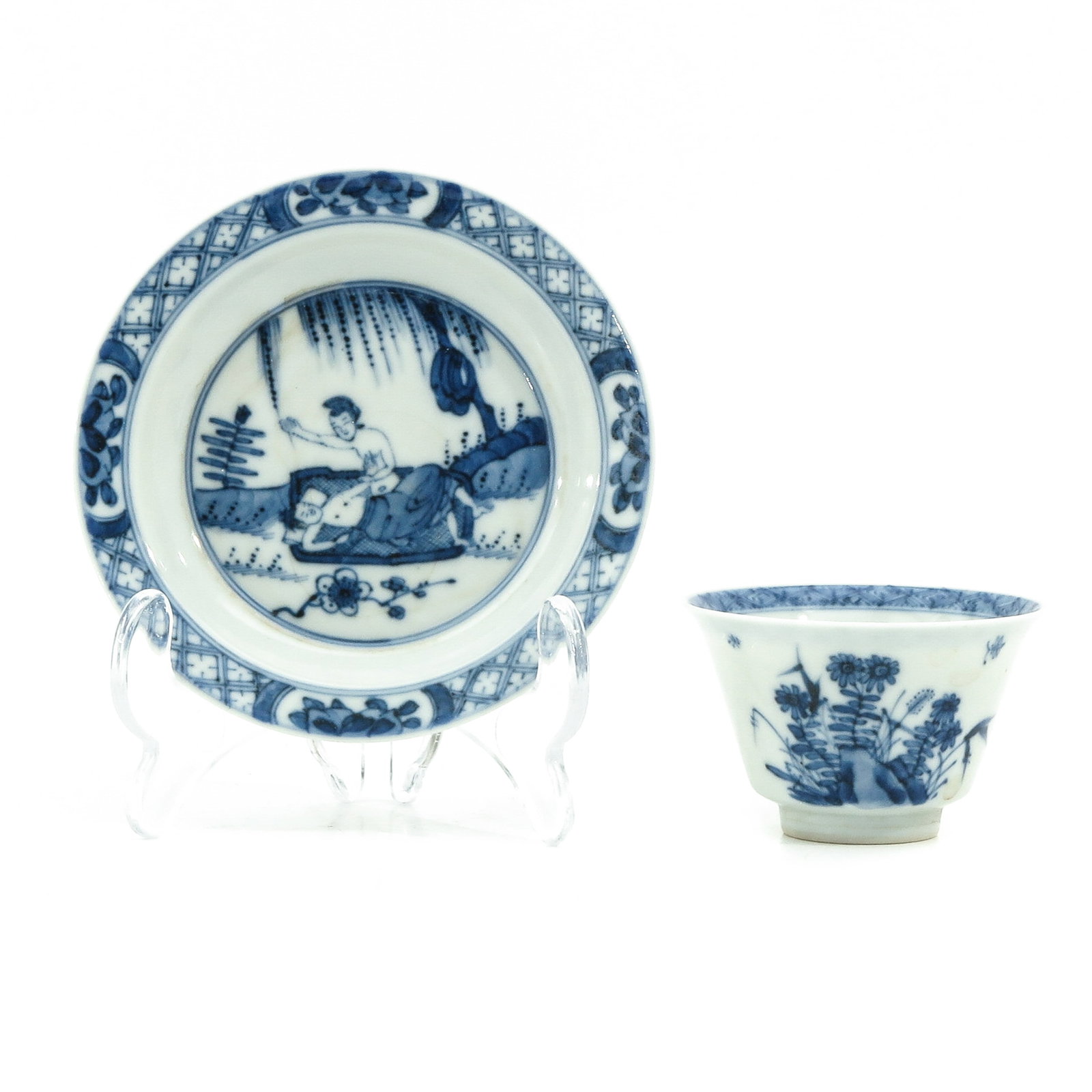A Blue and White Cup and Saucer: Depicting erotic scene with Chinese figures in garden, Chenghua mark, saucer is 11 cm. in diameter.