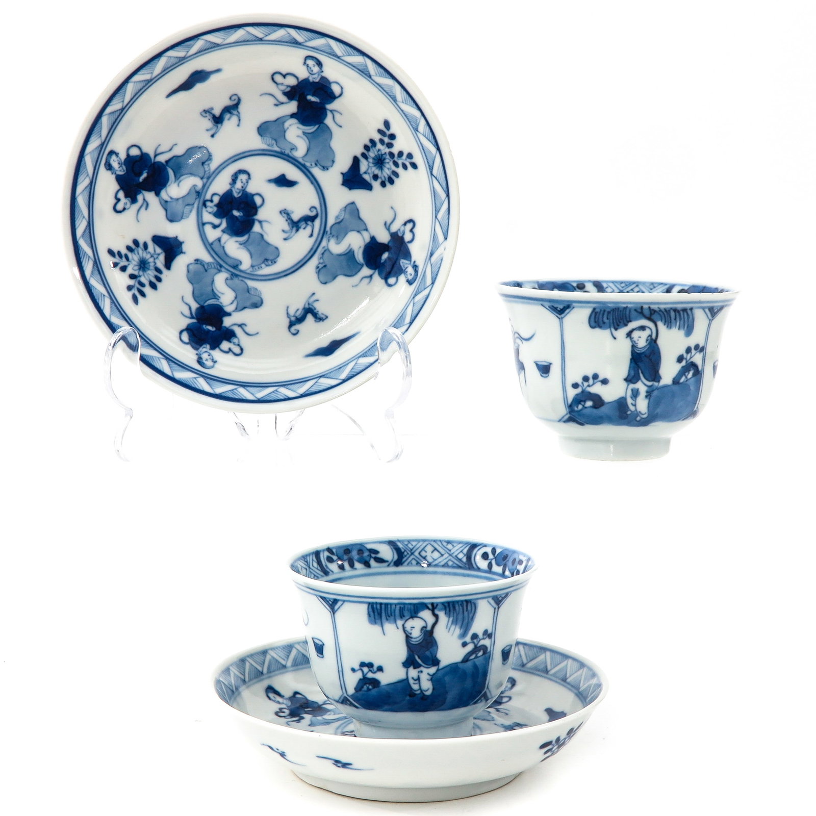 A Pair of Blue and White Cups and Saucers: Depicting Chinese ladies with dogs on saucers and Chinese ladies with antiquities on cups, saucers are 13 cm. in diameter.