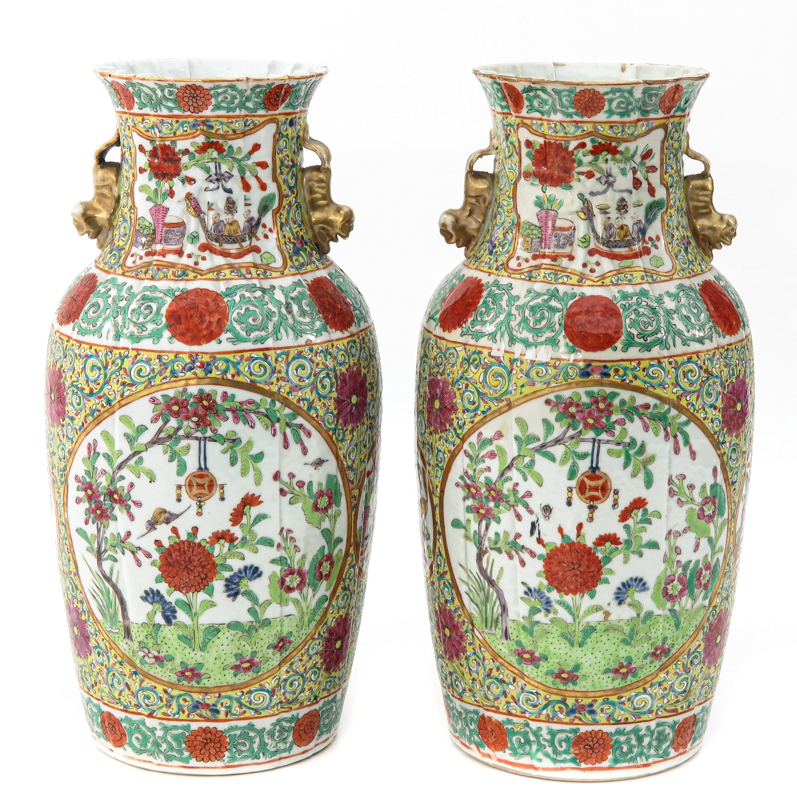 A Pair of Famille Rose Vases: Decorated with scenes in garden with flowers, temple lion figural handles, 38 cm. tall.
