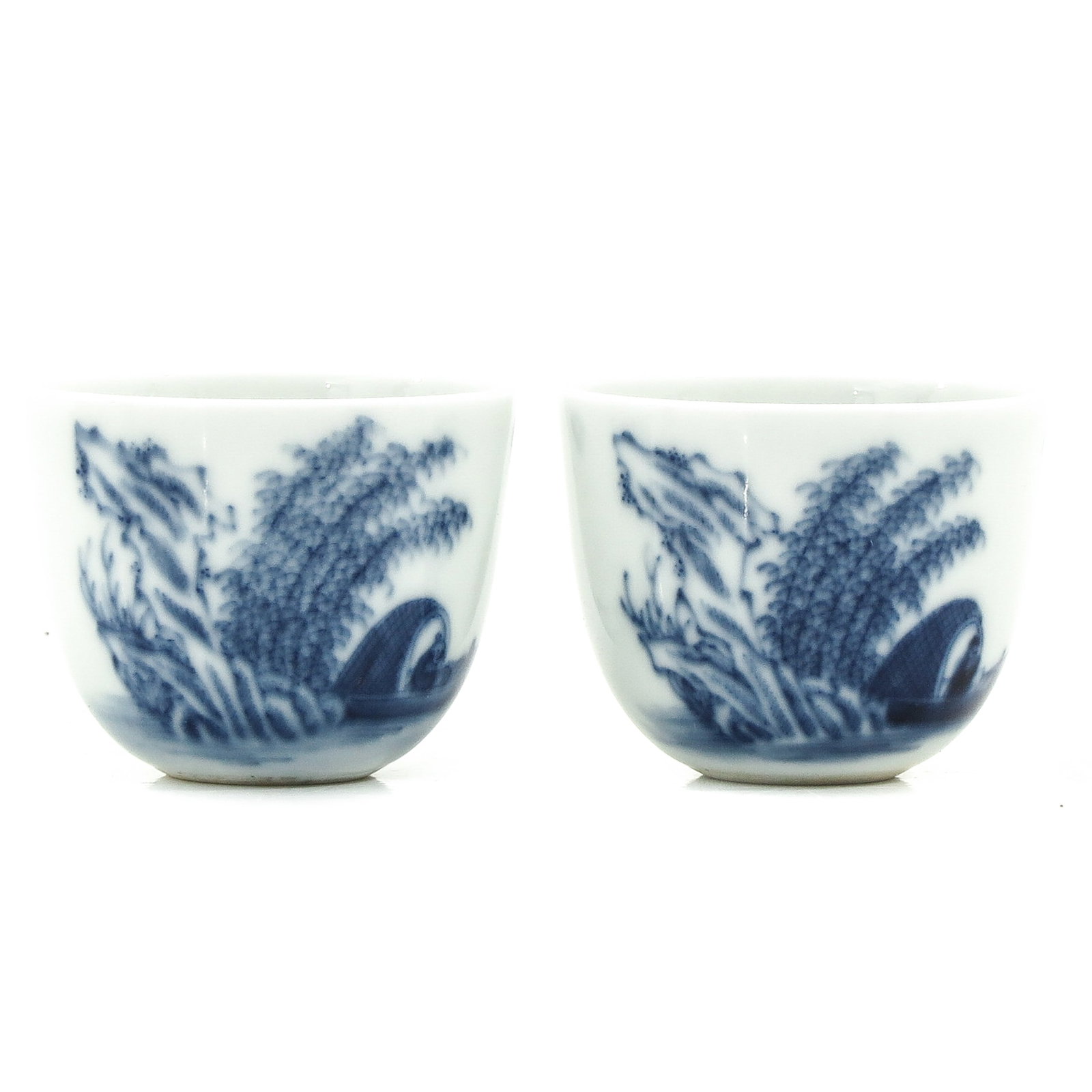 A Pair of 2 Blue and White Cups: Depicting Chinese figure in boat, 5 cm. in diameter.