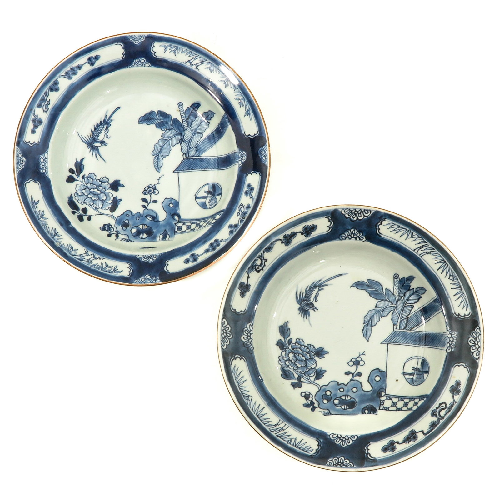 A Pair of Blue and White Plates: Depicting scene in garden with rocks, flowers, and birds, 18th Century, 23 cm. in diameter.