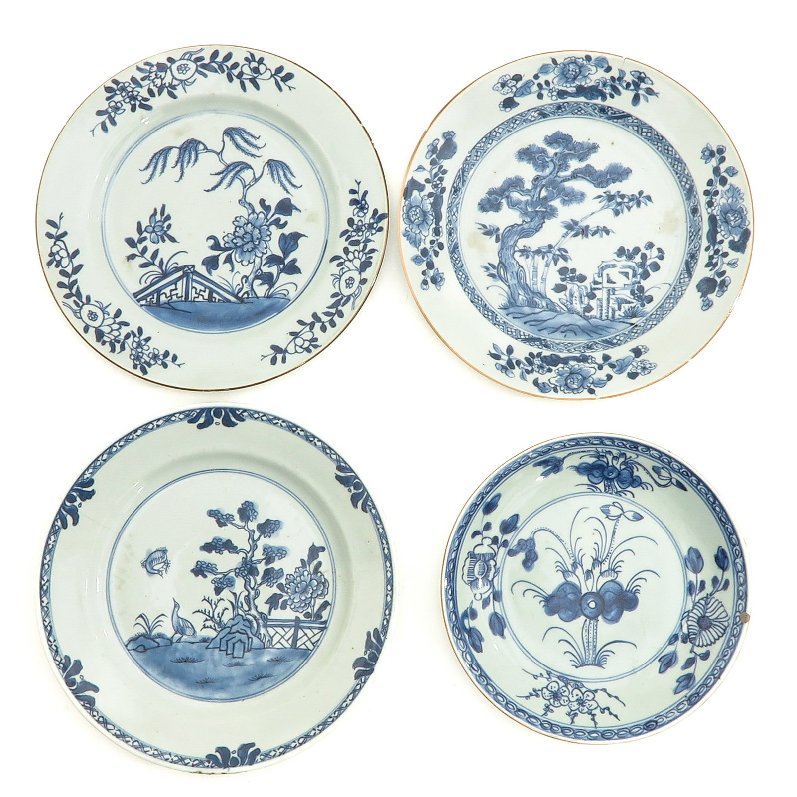 A Varied Collection of 4 Blue and White Plates: Landscape and floral decors, including 18th Century, 23 cm. in diameter, chip and hairline.