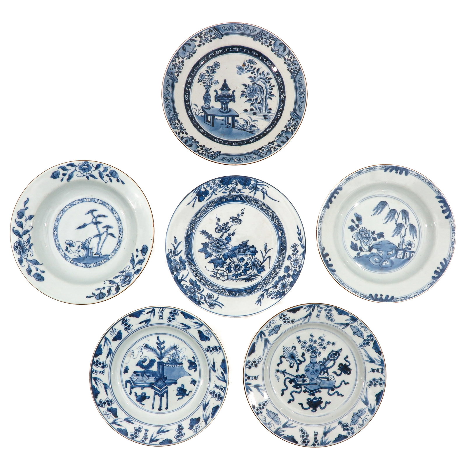 A Collection of 6 Blue and White Plates: In a variety of decors, 18th Century, 23 cm. in diameter, chip.