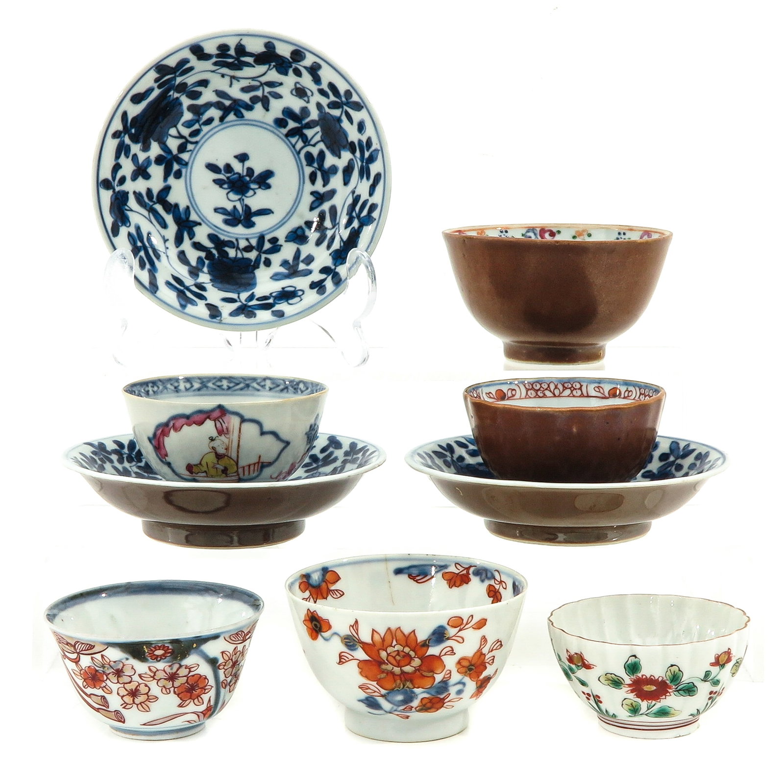 A Varied Group of Cups and Saucers: 9 pieces, in diverse decors, including 18th Century, largest saucer is 11 cm. in diameter, chip and hairline.