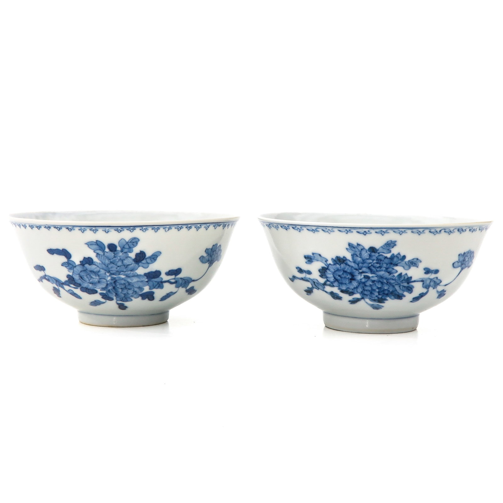 A Pair of Blue and White Bowls: Floral decor, Guangxu Period, 13 cm. in diameter, restored hairline.