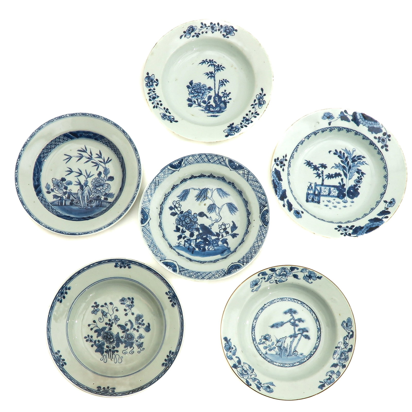 A Varied Collection of Blue and White Plates: In diverse decors, including 18th Century, 24 cm. in diameter, chip and hairline.