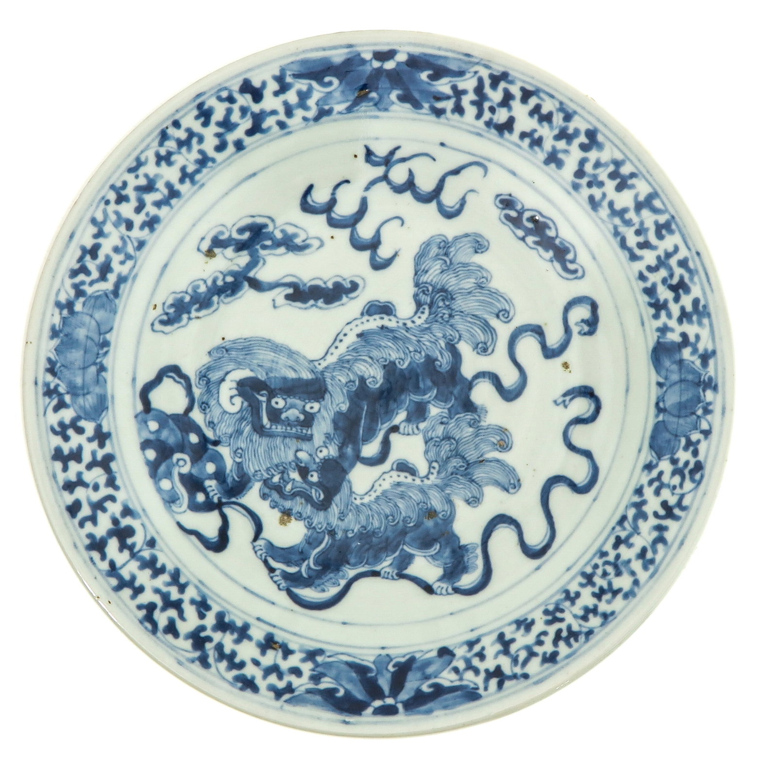 A Blue and White Plate: Decorated with temple lions, 26 cm. in diameter, chip.