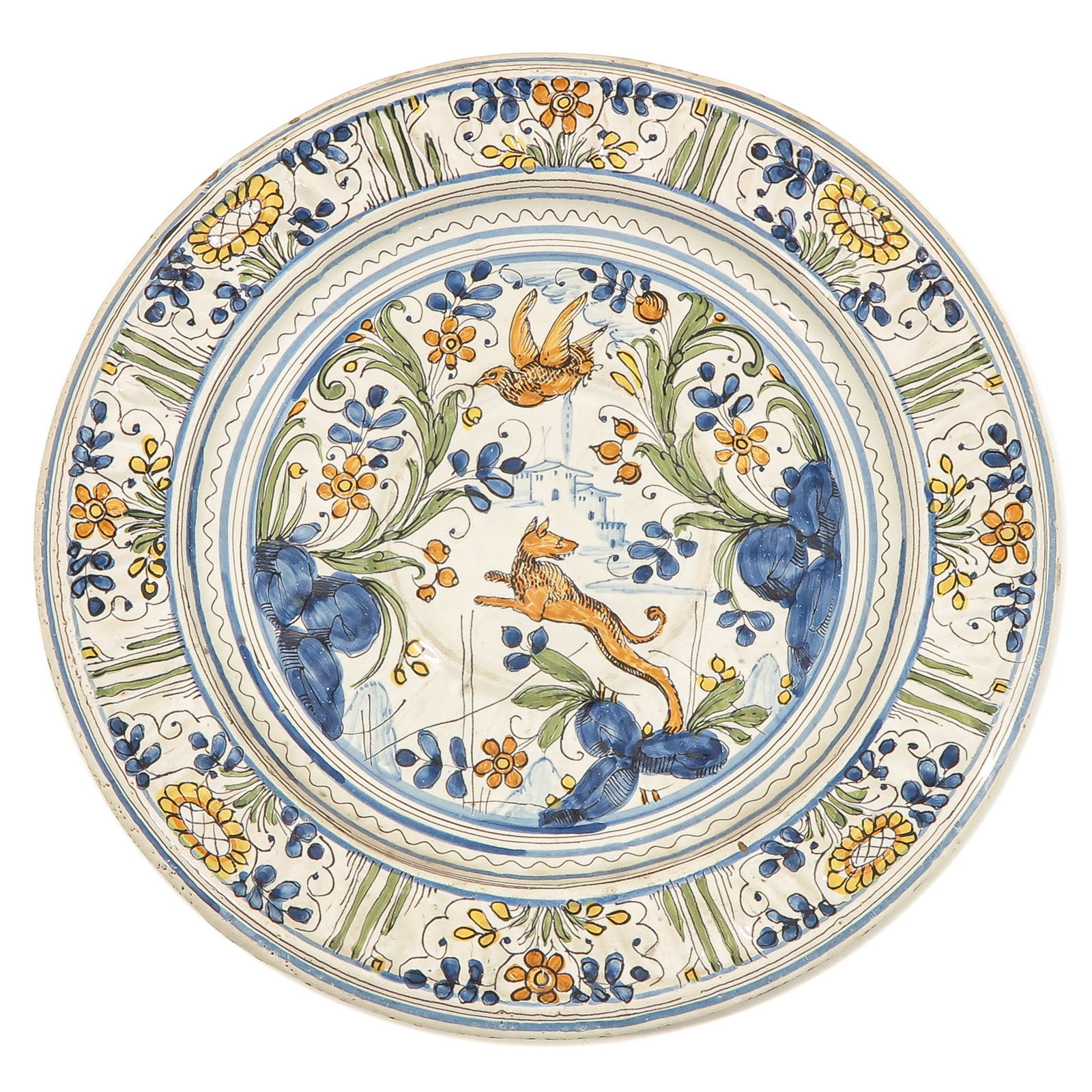 A Dish: decorated in blue, yellow, orange, olive green and manganese. In the middle a jumping fox above which a bird, the edge divided into eight panels with flowers and leaves, probably Bassano, circa 1670, 