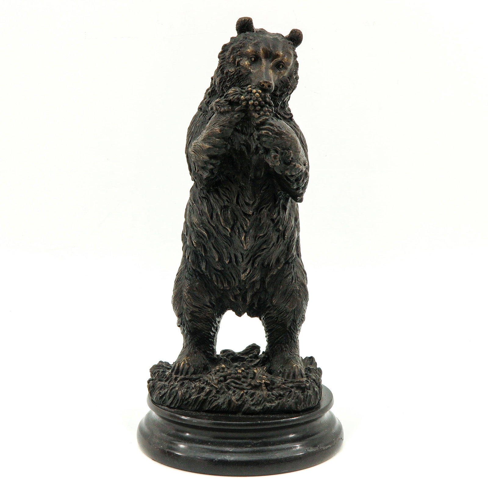 A Bronze Sculpture: bronze on marble base, depicting a bear, height 32 cm.