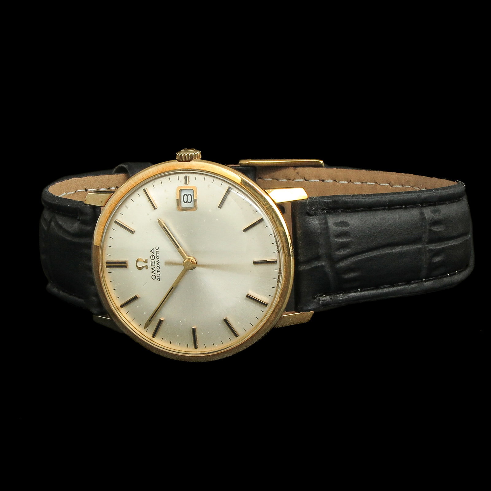 A Men's Watch: brand Omega, automatic, 1960s, 18 carat gold case, on leather strap, case diameter 33 mm.