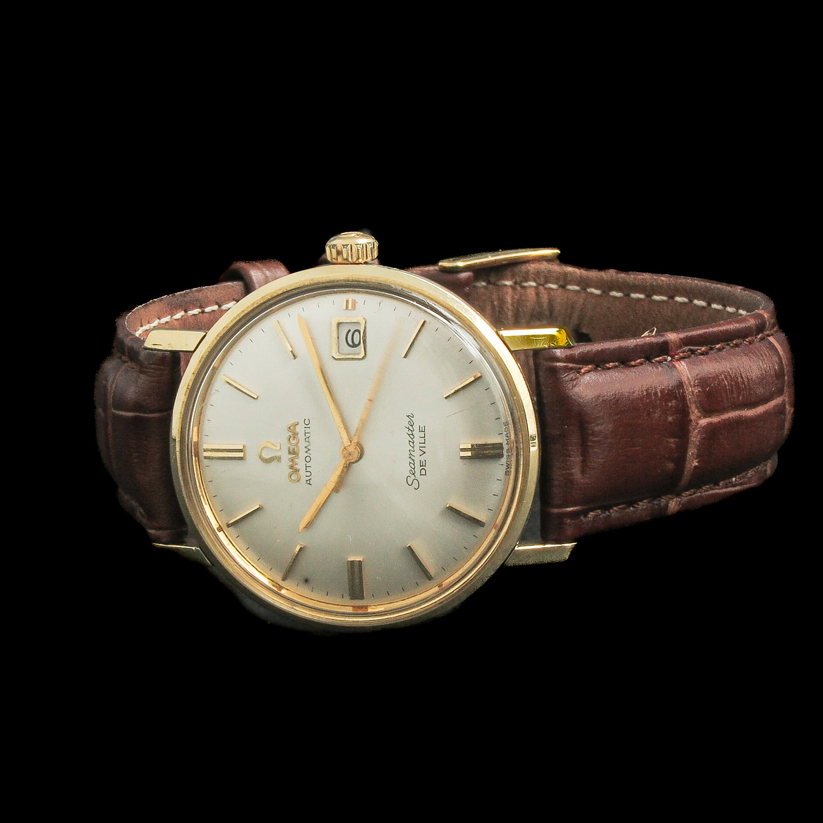 A Men's Watch: Omega, Seamaster De Ville, gold and steel, on leather strap, case diameter 34 mm.