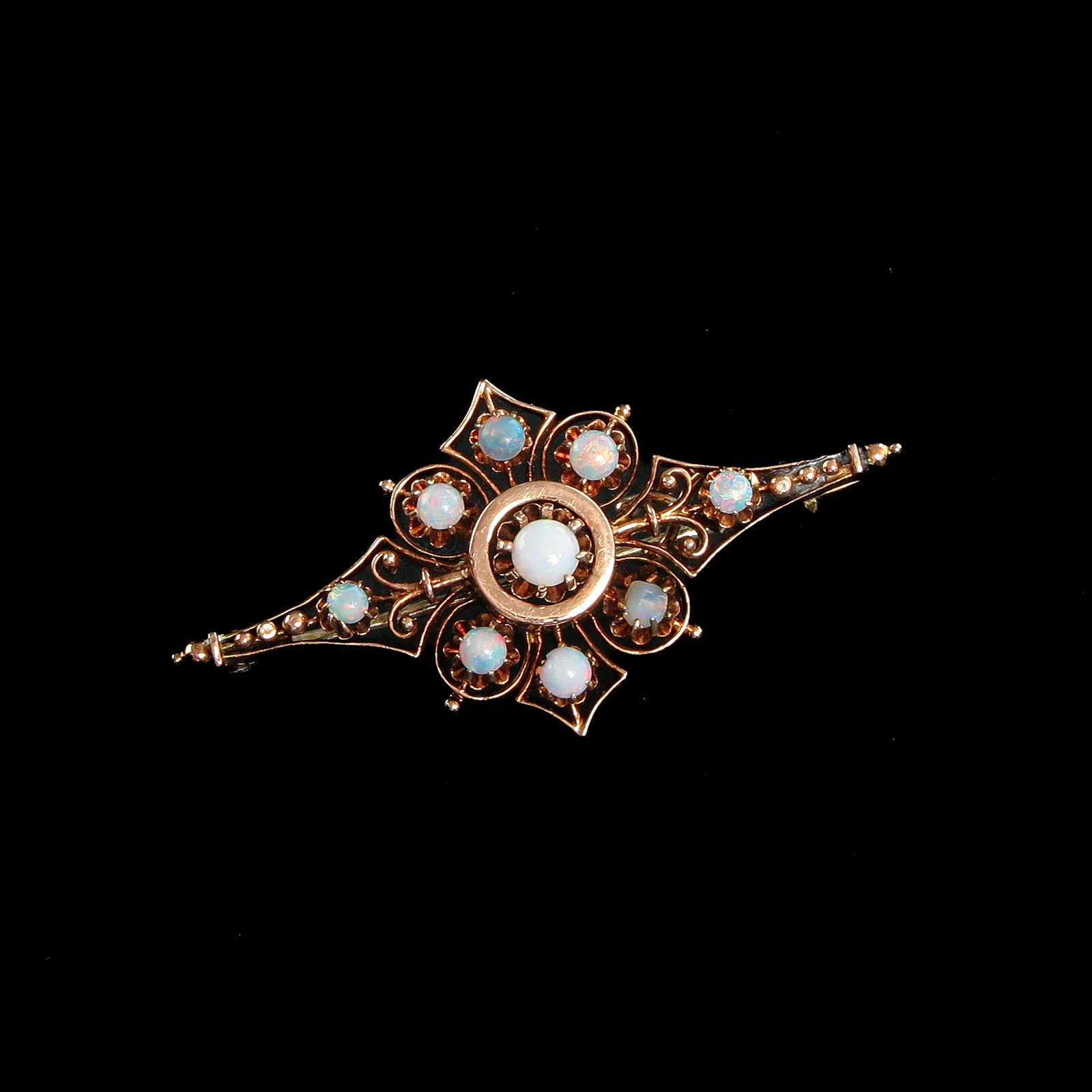 A Brooch: gold, set with 9 opals, length 38 mm.