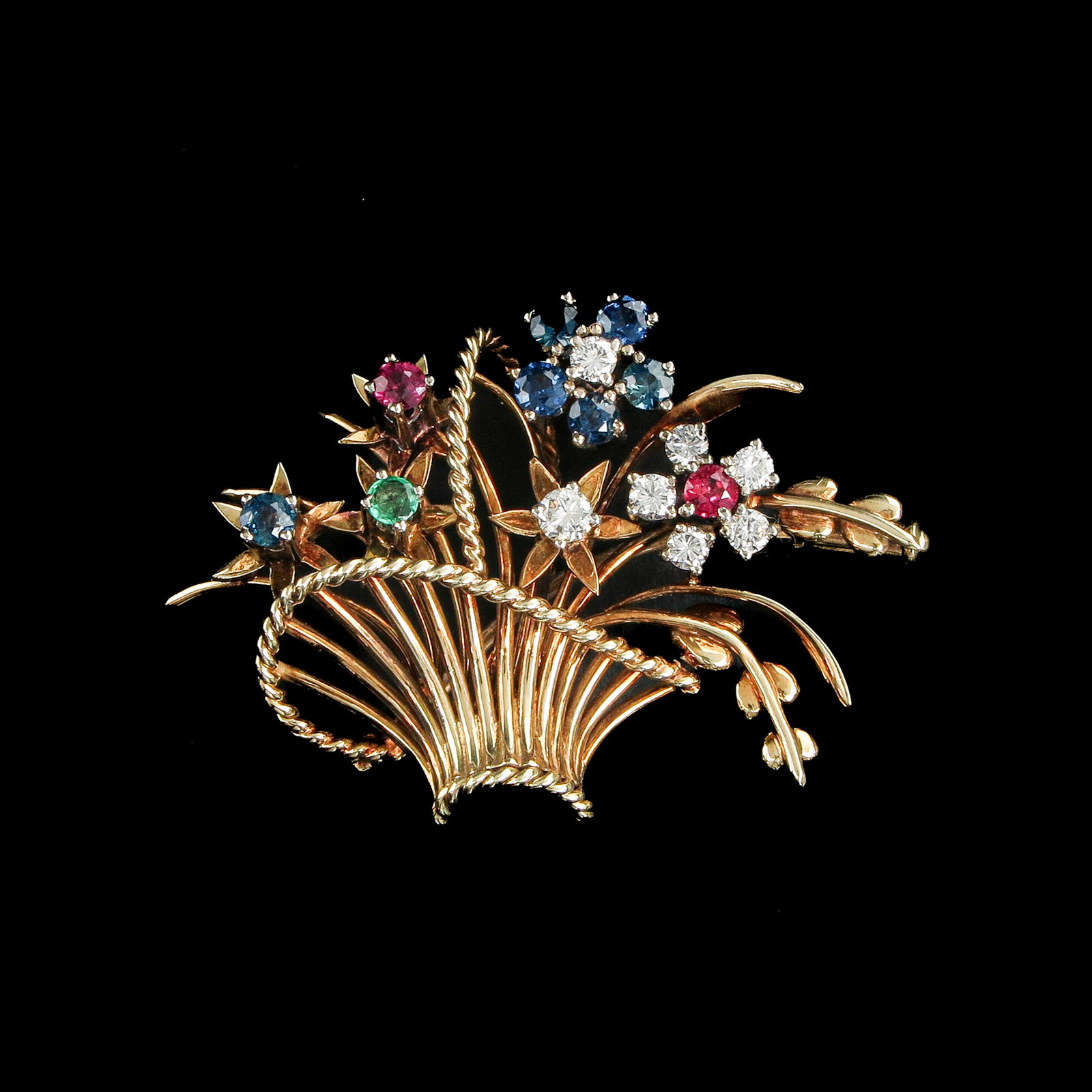 A Brooch: 14 carat gold, set with diamonds, sapphires and rubies, width 40 mm.