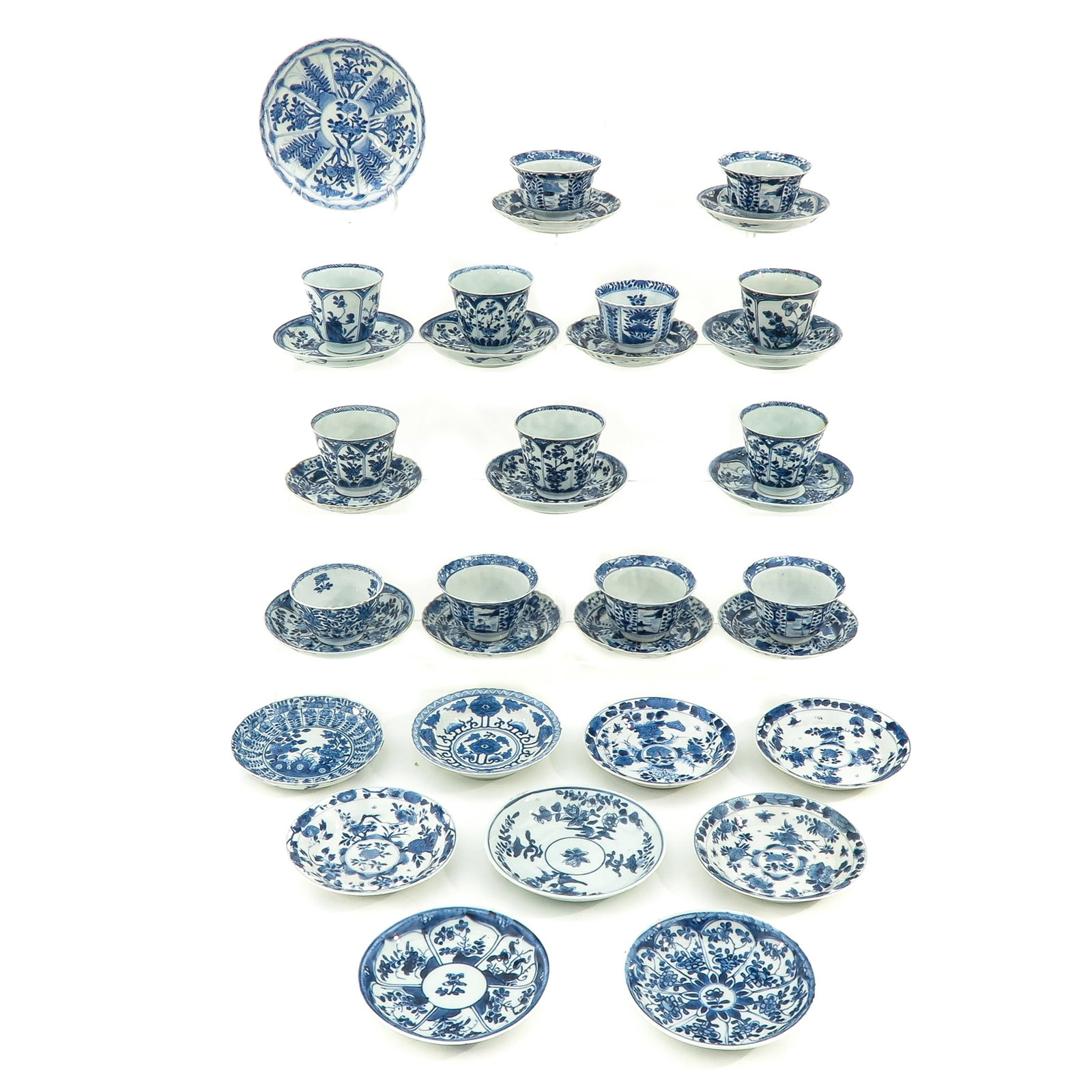 A Large Collection of Cups and Saucers: In a variety of blue and white decors, including Kangxi Mark and Period, largest saucer is 13 cm. in diameter, chip and hairline.