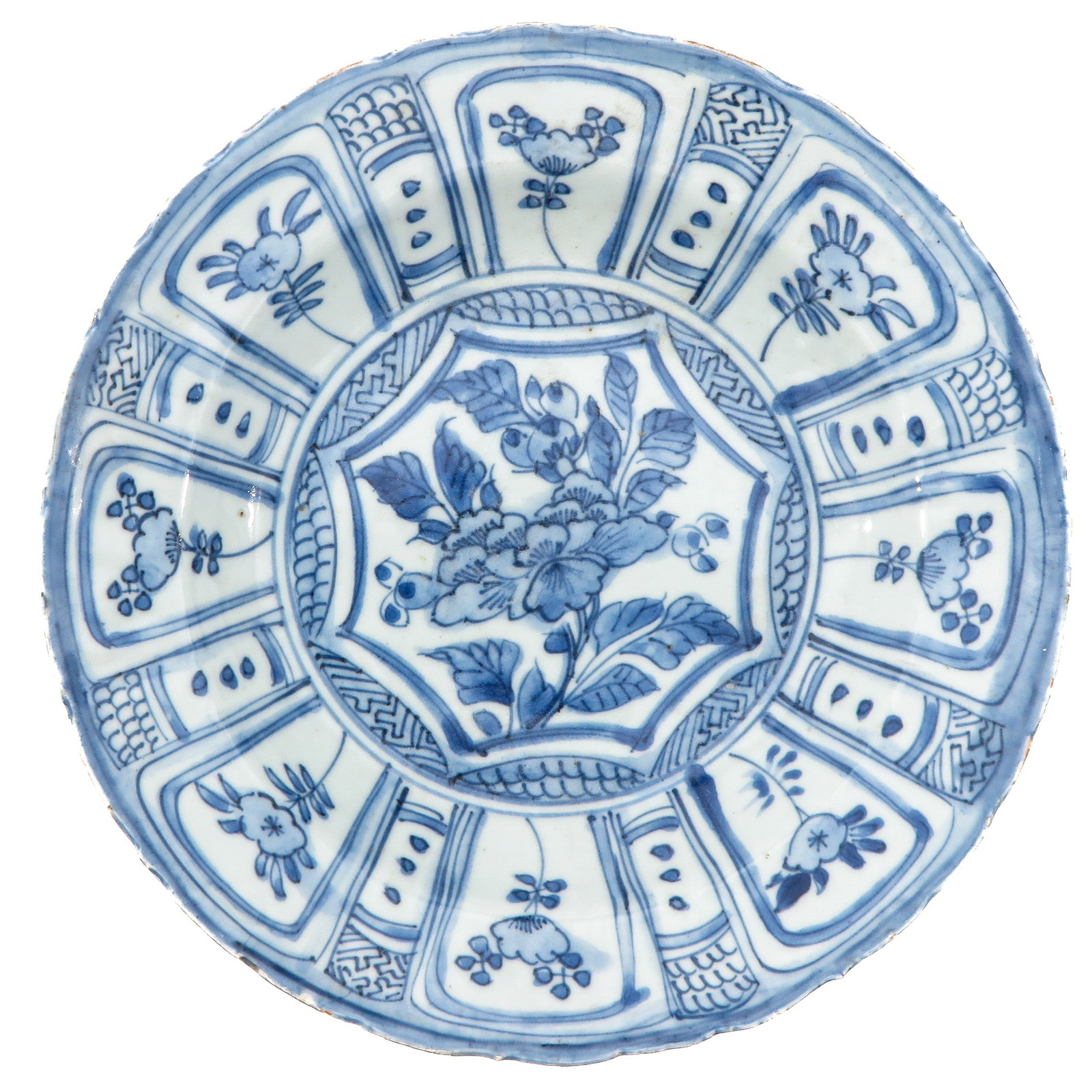 A Blue and White Wanli Plate: Decorated with cartouches of flowers, Wanli Period, 21 cm. in diameter, fritting.