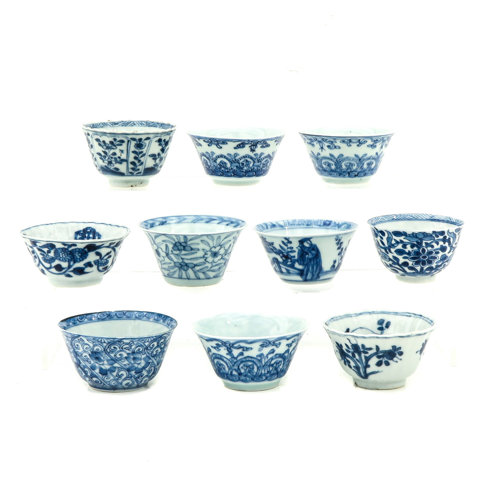 A Collection of 10 Blue and White Cups: In a variety of decors, including 18th Century, largest cup is 7 cm. in diameter, chip and hairline.