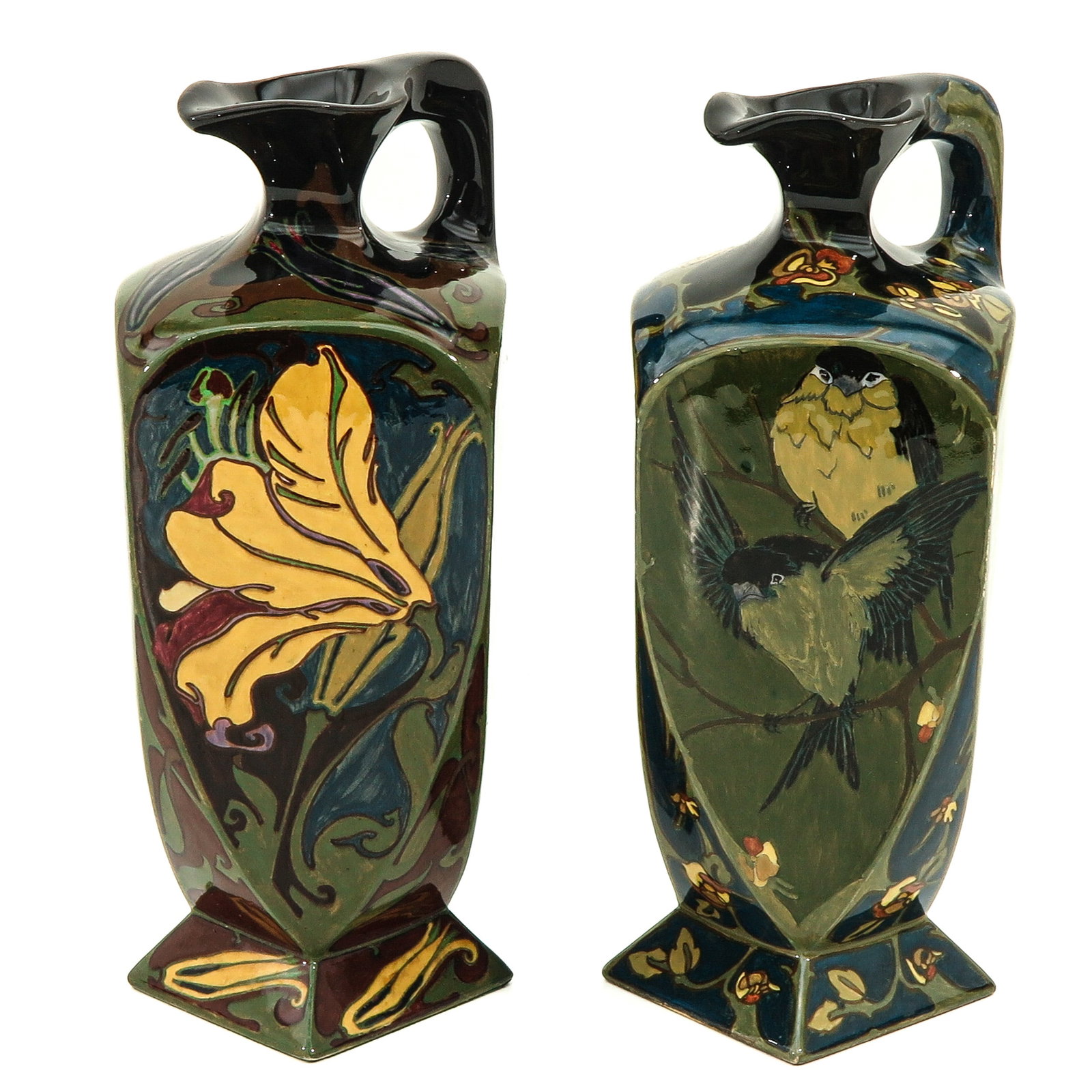 A Pair of Rozenburg Jugs: marked Rozenburg The Hague, H.G.A. Huyvenaar, w.o. H.G.A. Huyvenaar, depicting flowers and birds, height 30 cm.