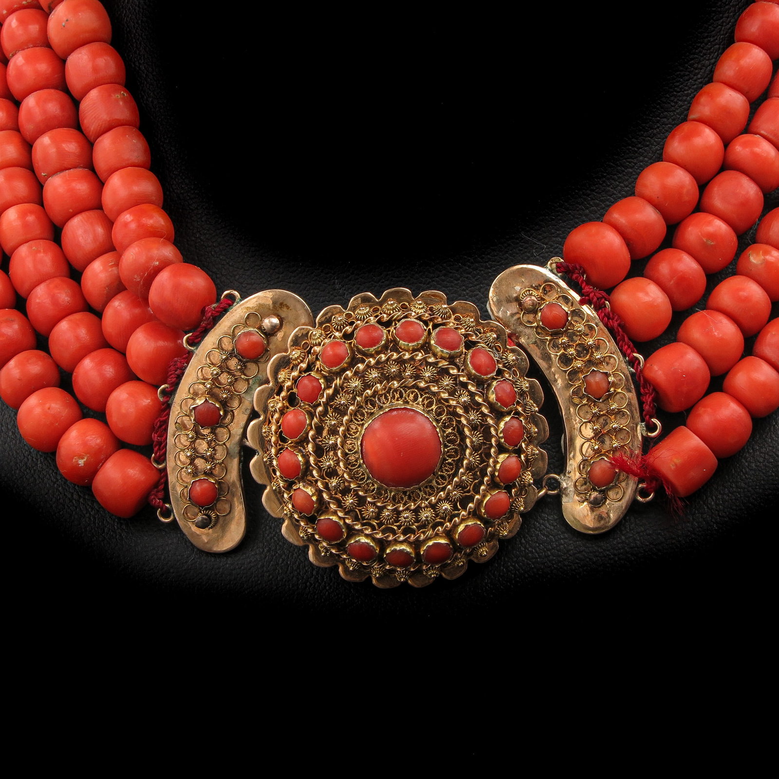 A 19th Century Red Coral Necklace: with 4 rows of blood coral, 19th century, Walcheren, 14 carat gold clasp, diameter beads 8 mm., weight 158 ??grams