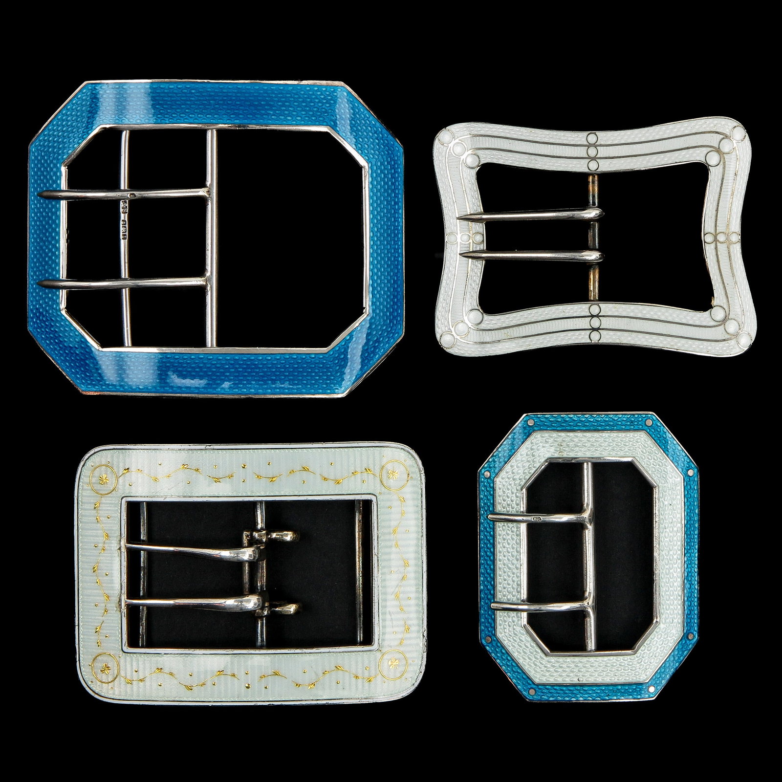 An Assortment of Silver Guilloché Buckles: consisting of 4 silver Guilloché enamelling buckles, including Germany, Birmingham, and the United States of America, longest 74 mm.