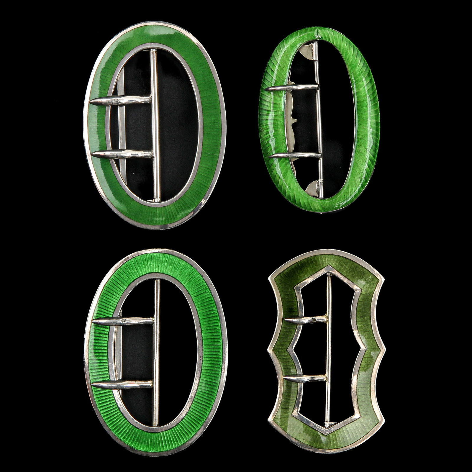 An Assortment of Silver Guilloché Buckles: consisting of 4 silver Guilloché enamelling buckles, Birmingham, longest 74 mm.