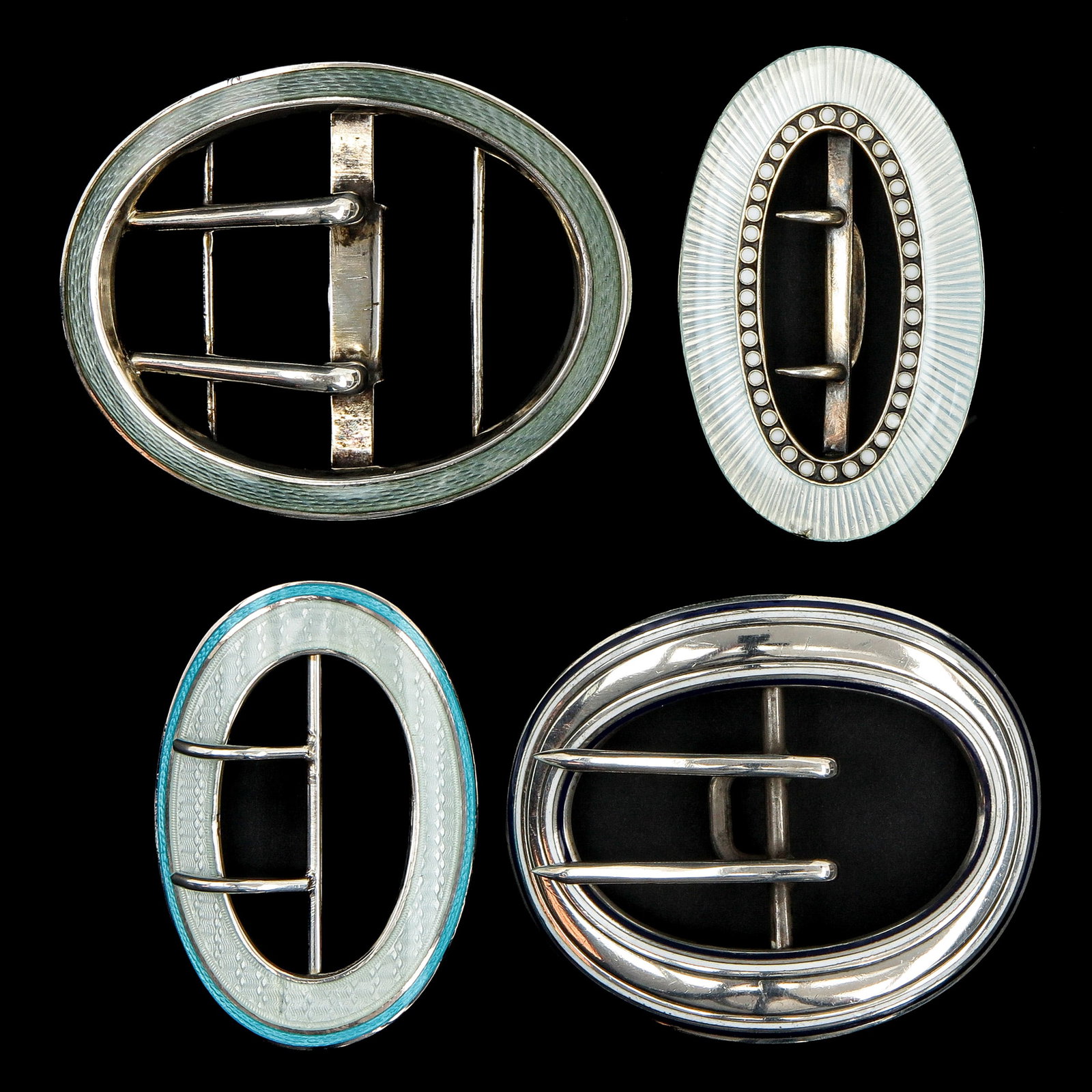 An Assortment of Silver Guilloché Buckles: consisting of 4 silver Guilloché enamelling buckles, including Germany, Birmingham, Norway and the United States of America, longest 74 mm.