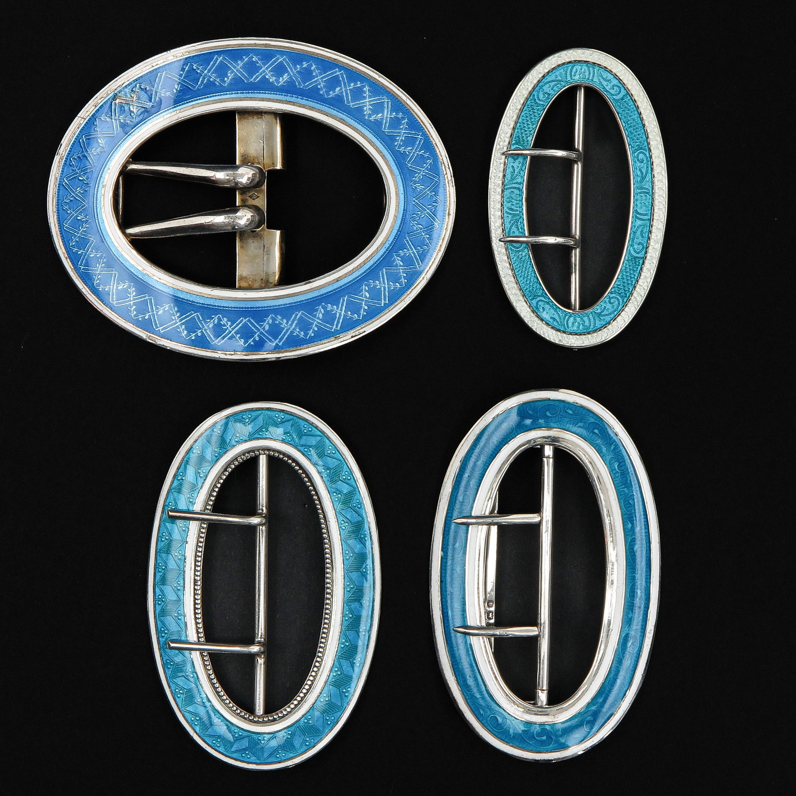 An Assortment of Silver Guilloché Buckles: consisting of 4 silver Guilloché enamelling buckles, including Germany and Birmingham, longest 84 mm.
