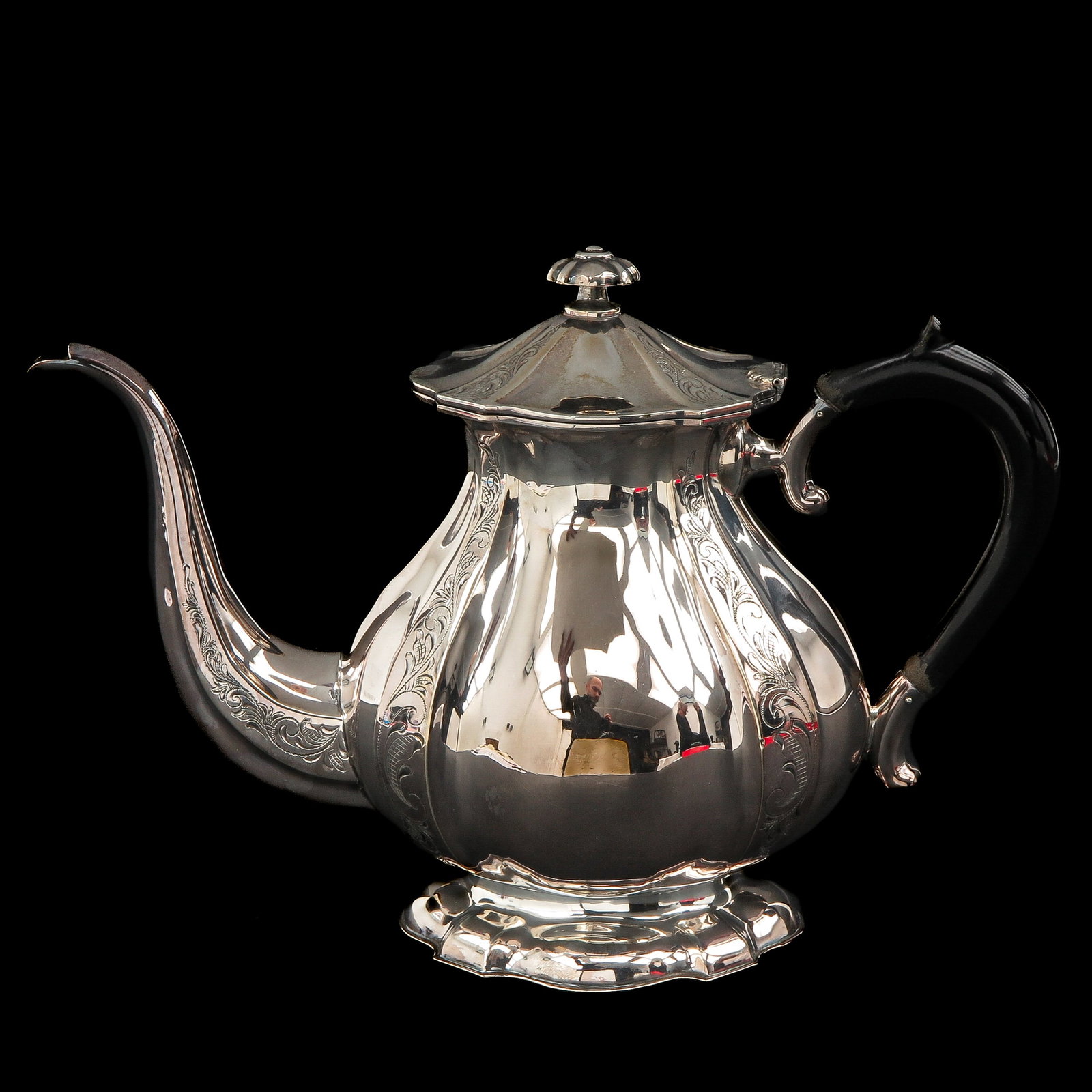 A Silver Teapot: silver, 835 / 1000, with wooden handle, height 19 cm.