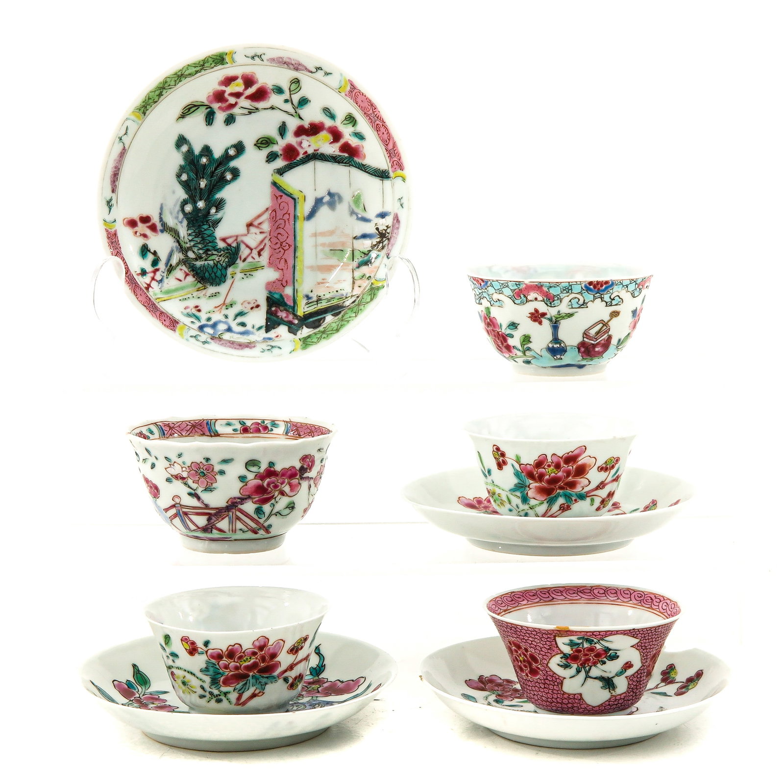 A Collection of Cups and Saucers: Including 5 cups and 4 saucers in a variety of Famille Rose decors, including 18th Century, largest saucer is 12 cm. in diameter, chip and hairline.