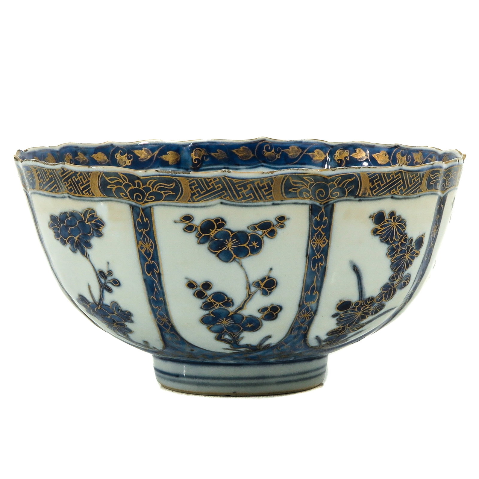 A Blue and White Bowl: Gilt accents, floral decor, Kangxi Period, 19 cm. in diameter, chip.