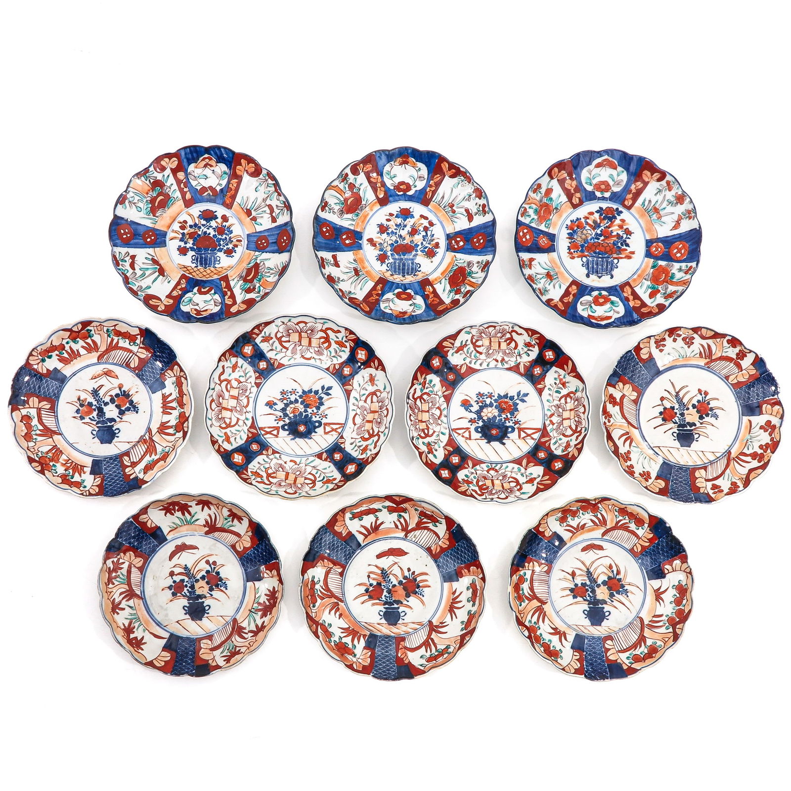 A Series of 10 Plates: Floral decor in iron red, blue and gilt enamels, 21 cm. in diameter, chip.