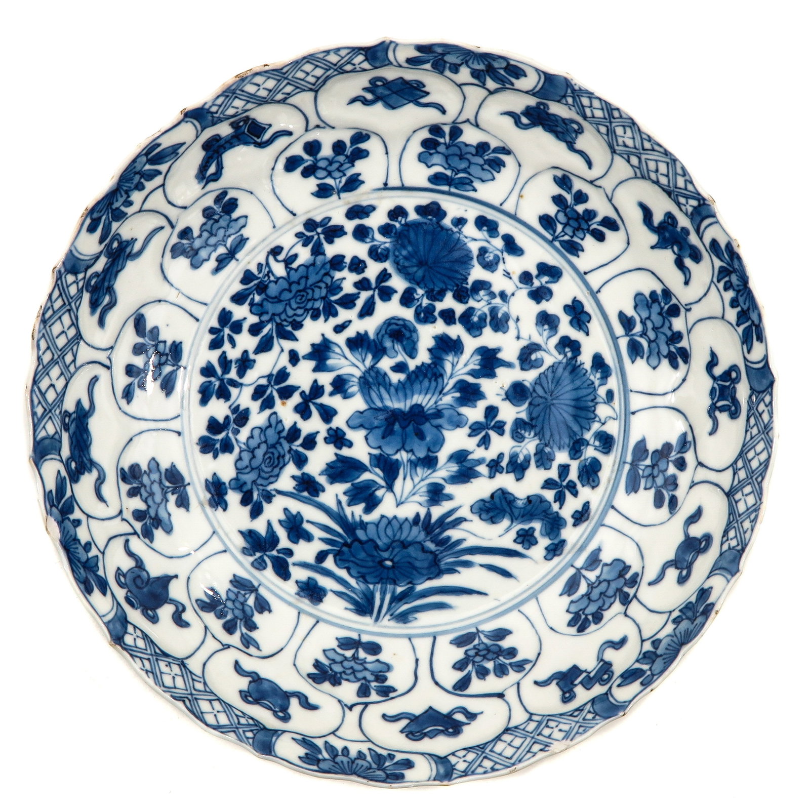 A Blue and White Dish: Floral decor, 18th Century, 22 cm. in diameter, chip