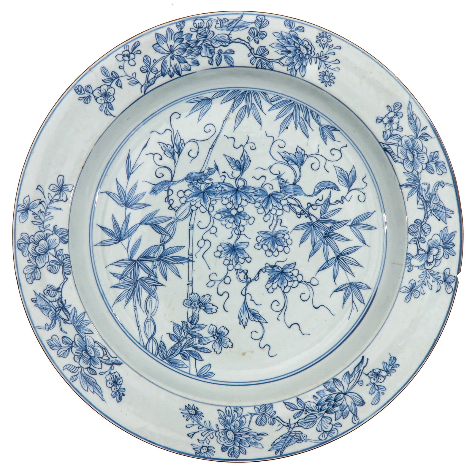 A Blue and White Charger: A rare scene depicting flowers and bamboo trees with a squirrel, Kangxi Period, 40 cm. in diameter, chip and hairline.
